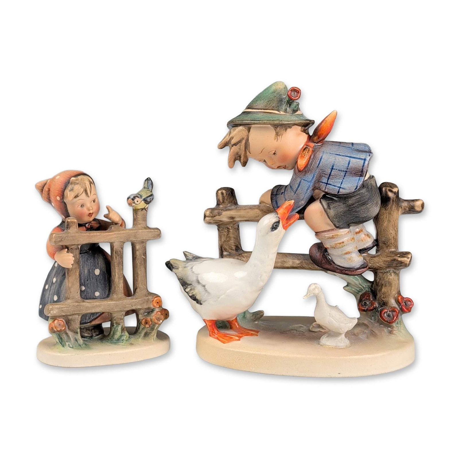 2pc Goebel Hummel Porcelain Figurines, Barnyard Hero and Signs of Spring: Goebel, Germany. Pair of hand-painted porcelain figurines in the classic Hummel style, including Barnyard Hero (model 195) and Signs of Spring (model 203). Barnyard Hero depicts a boy in a Tyrolean-st