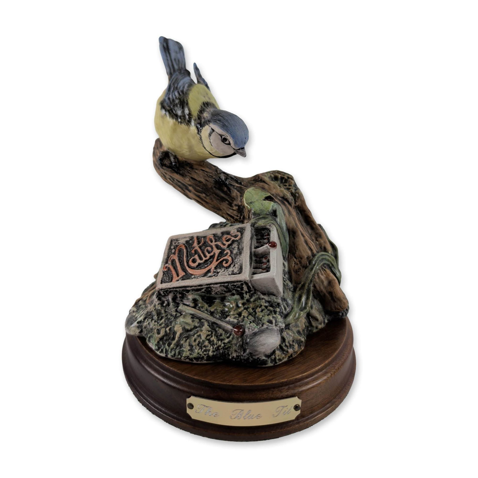 Royal Doulton Blue Tit Porcelain Figurine: Royal Doulton Garden Birds Collection. Figurine in hand-decorated porcelain titled The Blue Tit, model DA 13, featuring a bird perched on a gnarled branch next to an open matchbox with matchsticks. Mo