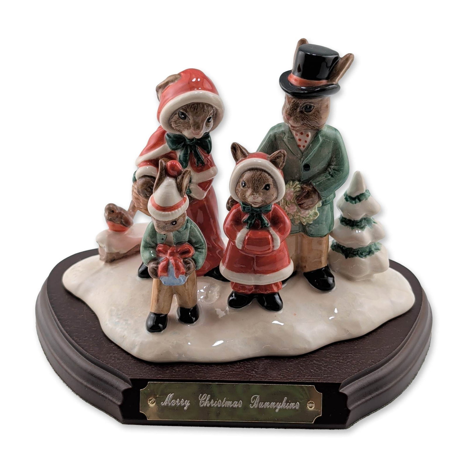 Royal Doulton LE Merry Christmas Bunnykins Porcelain Tableau DB194 with Base: This millennium commemoration edition features a family of four anthropomorphic rabbits in Victorian winter dress, including a father in a green coat and top hat, mother in a red hooded cloak, and two