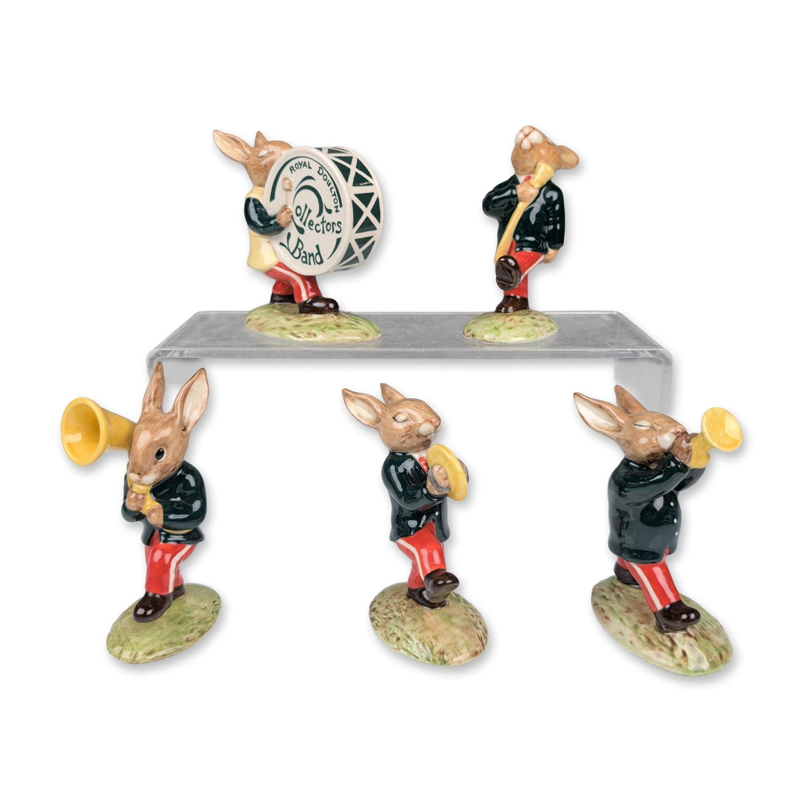 Royal Doulton Bunnykins Oompah Band Figurine Group: Royal Doulton group of Bunnykins figurines from the Oompah Band series, 1991. Constructed from glazed ceramic, the collection features rabbit musicians in marching band attire with black tunics and re