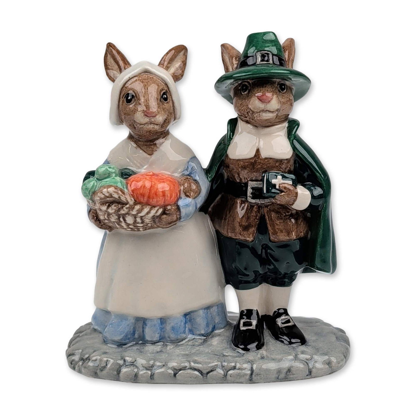 Royal Doulton Pilgrim Bunnykins Porcelain Figurine DB212: Royal Doulton glazed porcelain figurine titled Pilgrim Bunnykins, model number DB 212. The piece depicts two anthropomorphic rabbits dressed as American pilgrims; the male figure wears a green buckled