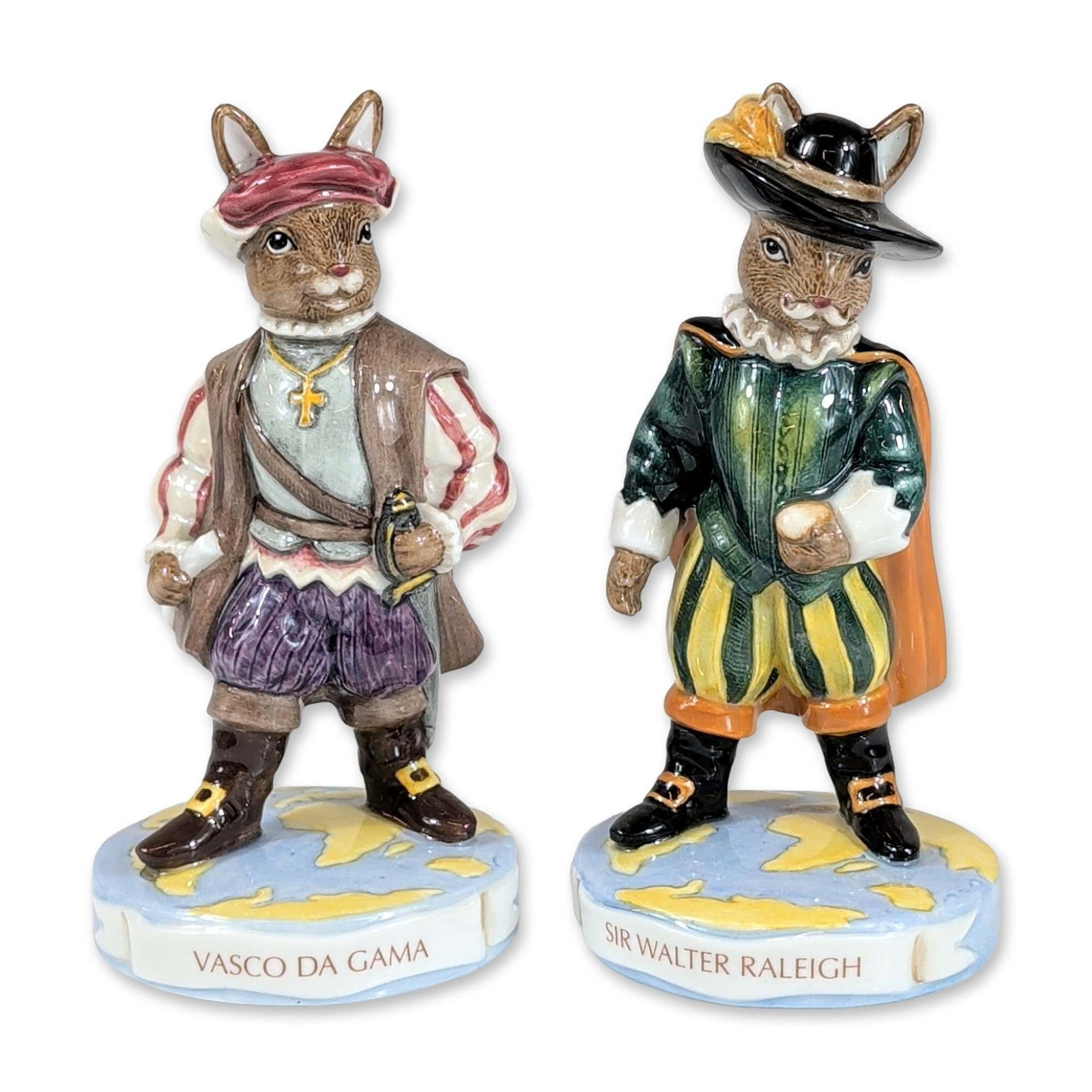 2pc Royal Doulton Bunnykins Explorer Figurines: Royal Doulton, 2007. Pair of hand-decorated ceramic figurines from the Bunnykins Explorers series, depicting Sir Walter Raleigh (DB 416) and Vasco Da Gama (DB 413). Sir Walter Raleigh is rendered in E
