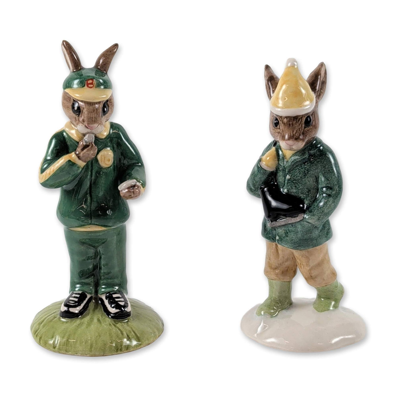 2pc Royal Doulton Bunnykins Porcelain Figurines: Royal Doulton (English). Two glazed porcelain figurines from the Bunnykins series. Includes "Boy Skater" (DB 152), issued in 1995, depicting a rabbit in a green coat and yellow cap on an ice-textured 