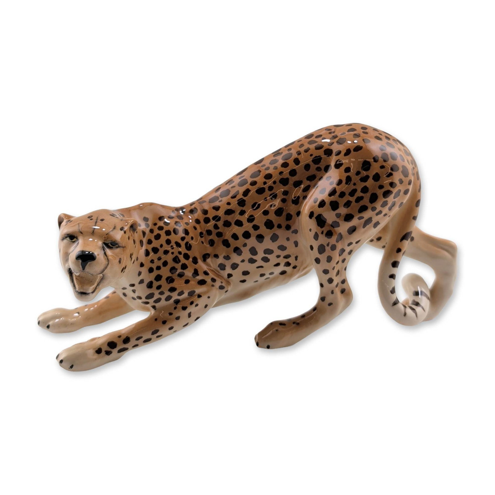 Beswick English Glazed Porcelain Cheetah Figurine: Beswick, England. Glazed ceramic figurine depicting a cheetah in a prowling stance with a curled tail. The piece is finished in a tan glaze with hand-painted dark brown to black spots and a high-gloss