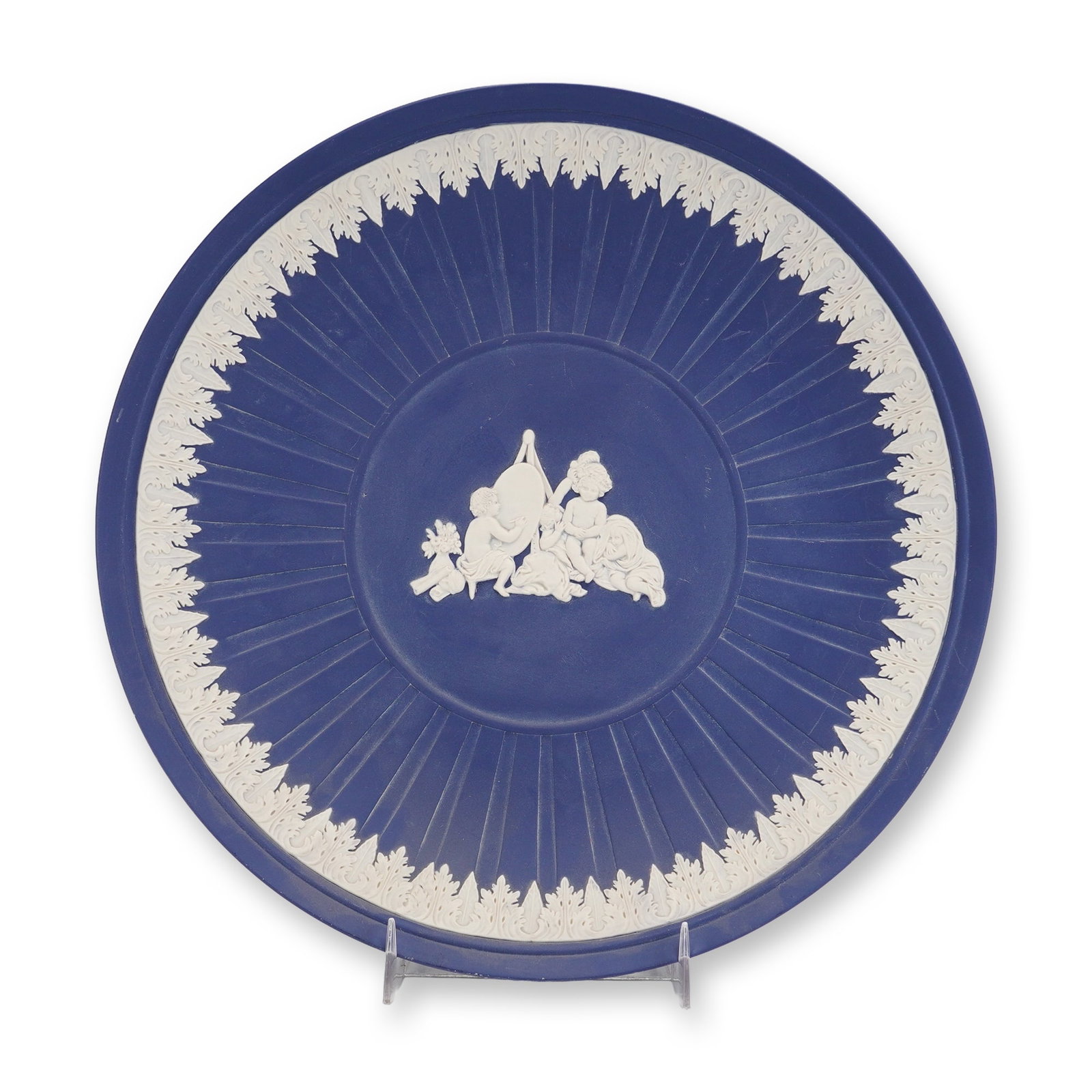 Wedgwood Jasperware Cobalt Blue Infant Academy Charger: A Wedgwood jasperware charger in cobalt blue featuring white bas-relief decoration. The central circular medallion depicts the Infant Academy scene, after the work of Sir Joshua Reynolds, showing four