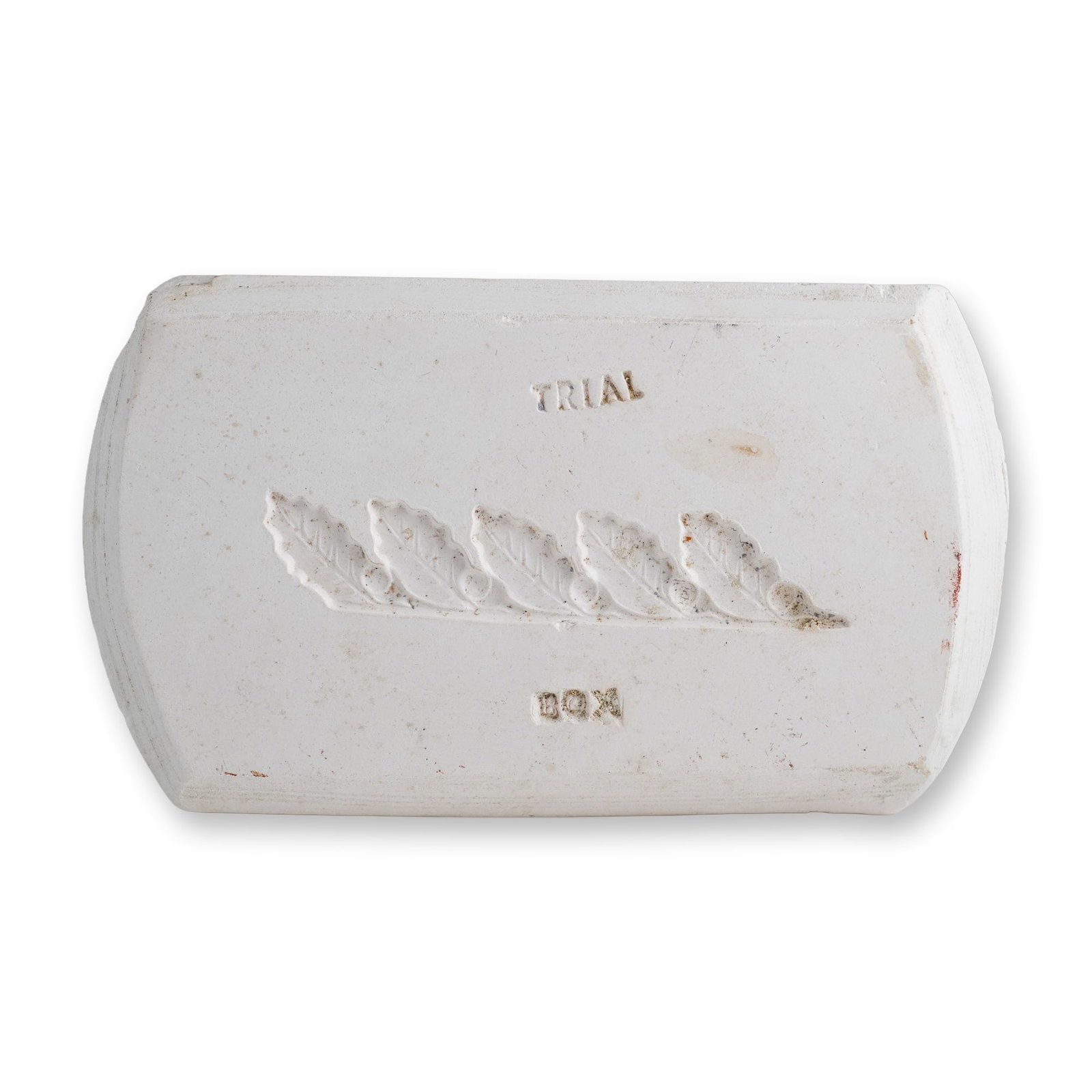 Wedgwood White Earthenware Sprig Trial Box Mold Block: A rectangular white earthenware Wedgwood trial sprig mold block used for testing relief decoration. The face features a recessed foliate sprig design of five overlapping leaves. The word TRIAL is impr