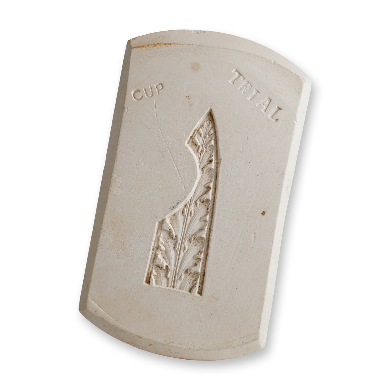 Wedgwood Cup Trial Ceramic Foliate Sprig Mold: This item is a Wedgwood factory ceramic sprig mold made of white unglazed biscuit ceramic or plaster. The rectangular block features a recessed intaglio design of a classical foliate motif, likely an 