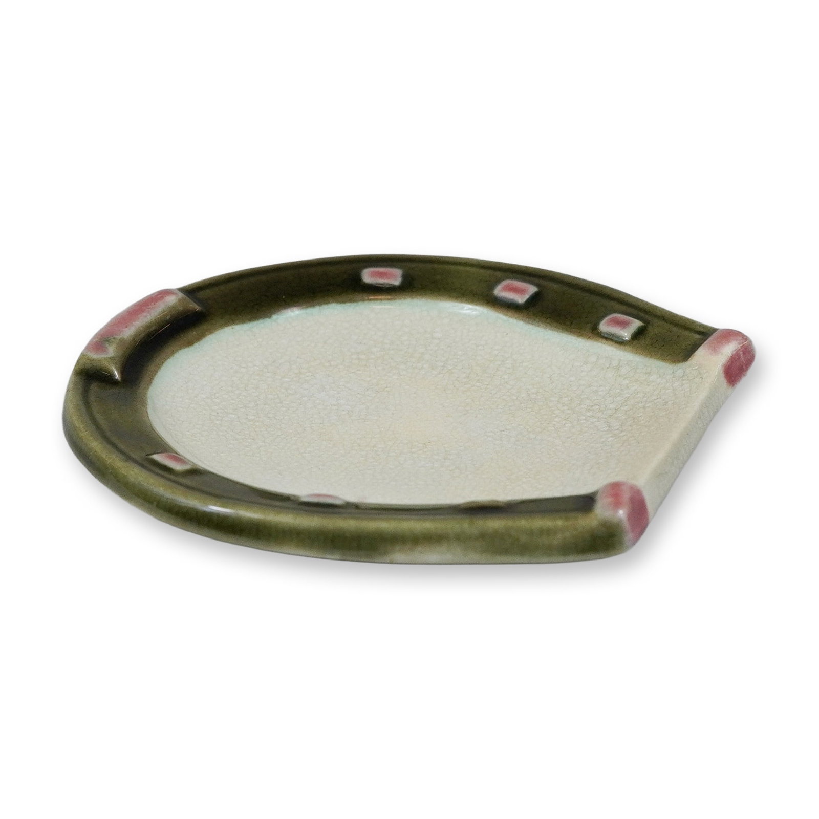 Wedgwood Horseshoe Ceramic Dish: A small ceramic dish manufactured by Wedgwood, modeled in the form of a horseshoe. The piece features a dark olive-green glazed rim punctuated with hand-applied rectangular accents in a pinkish-mauve 