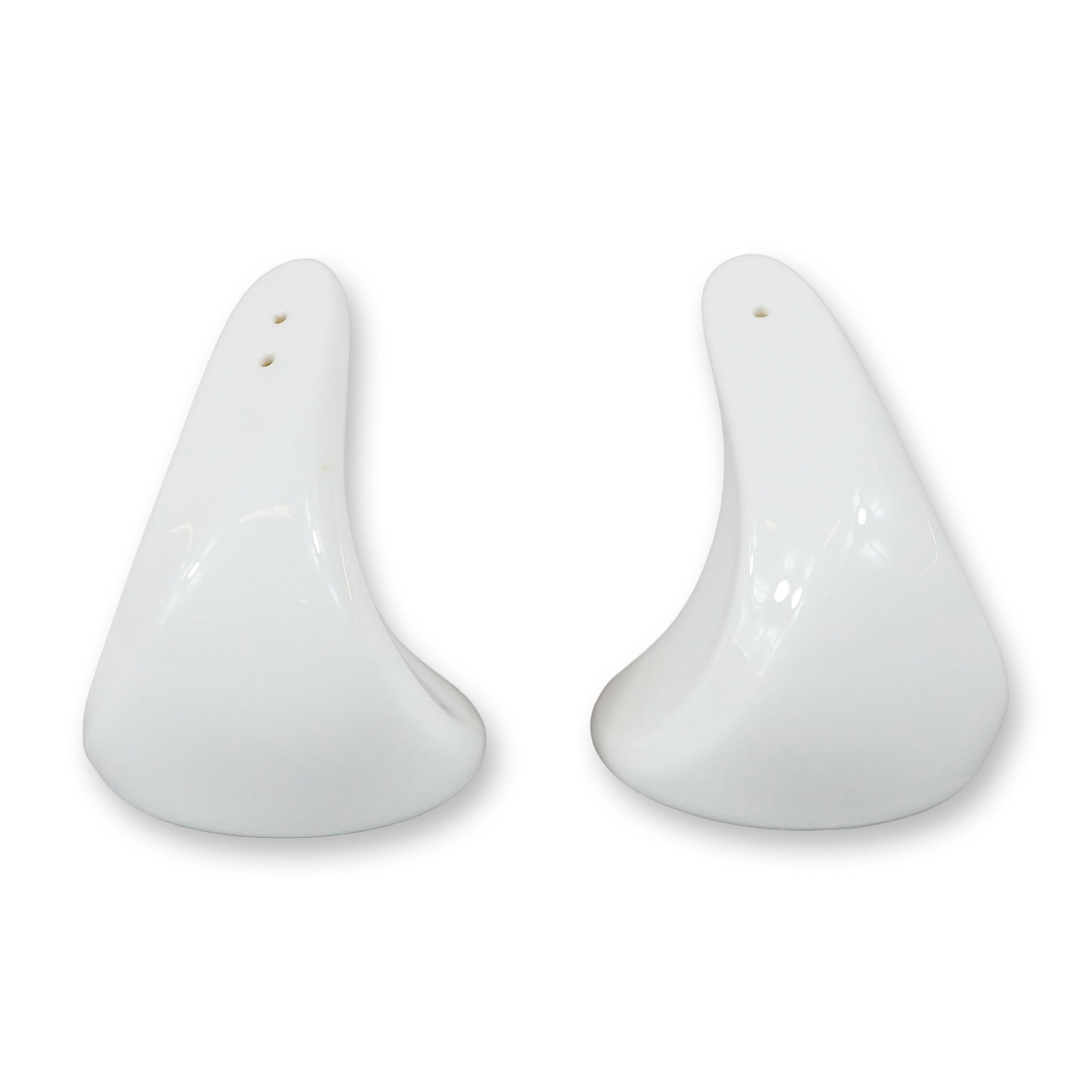 A Pair of Wedgwood Hotelware Salt and Pepper Shakers: A pair of white glazed ceramic salt and pepper shakers by Wedgwood. These pieces are part of the Wedgwood Hotelware collection and feature a distinct modernist, organic sculptural form with a swept-ba