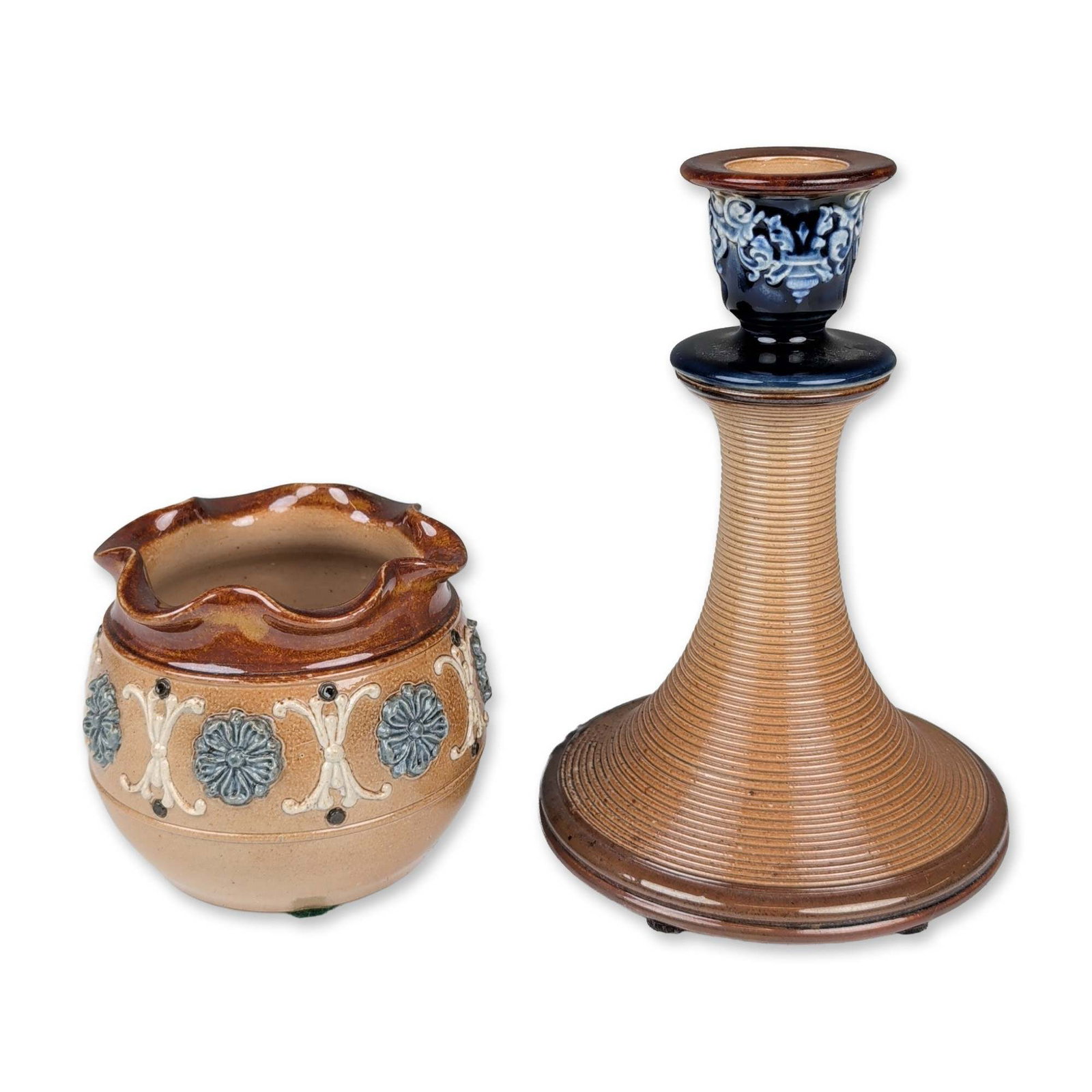 Two Doulton Lambeth Stoneware Table Objects: Doulton Lambeth late 19th to early 20th century stoneware grouping comprising two decorative table objects finished with multi-toned salt glazes. Includes a candlestick with a ribbed conical base, dar