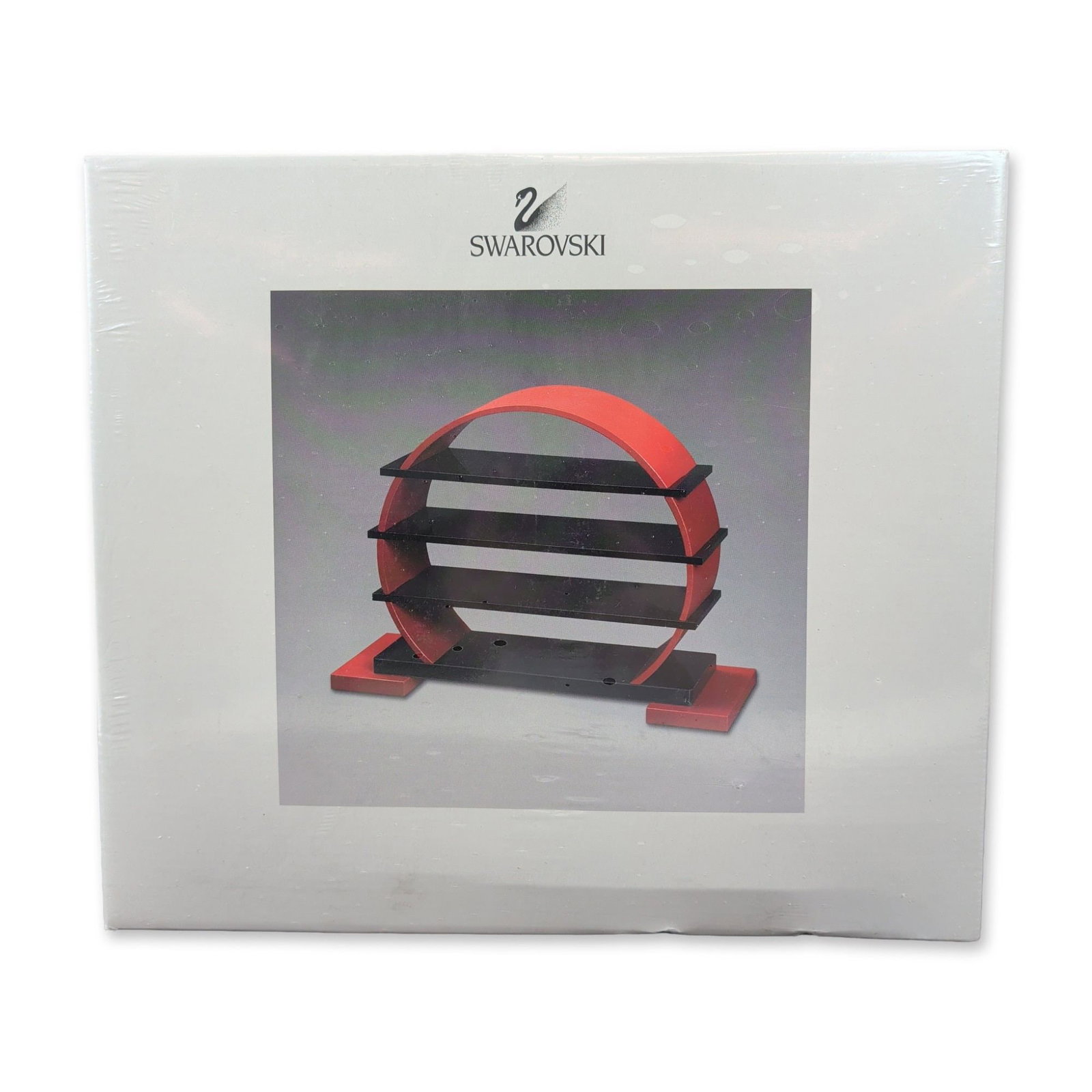 Swarovski Chinese Zodiac Display Stand: Designed specifically for displaying Swarovski crystal figurines, this piece features a modern design with a red circular arch intersected by black vertical shelves, mounted on a T-shaped black base w