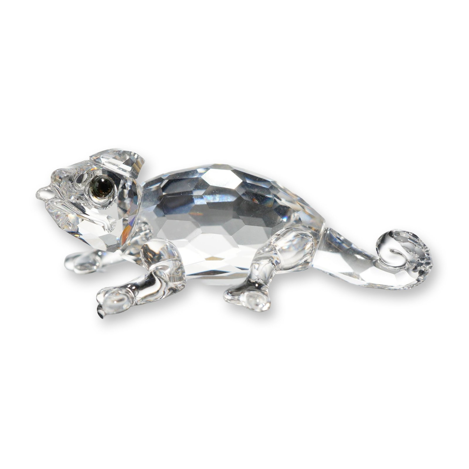 Swarovski Crystal Chameleon Figurine: This piece features a faceted clear crystal body with a smooth molded crystal head, splayed legs, and a curled tail. The eyes are accented with small, inset dark crystals. Features an etched Swarovski