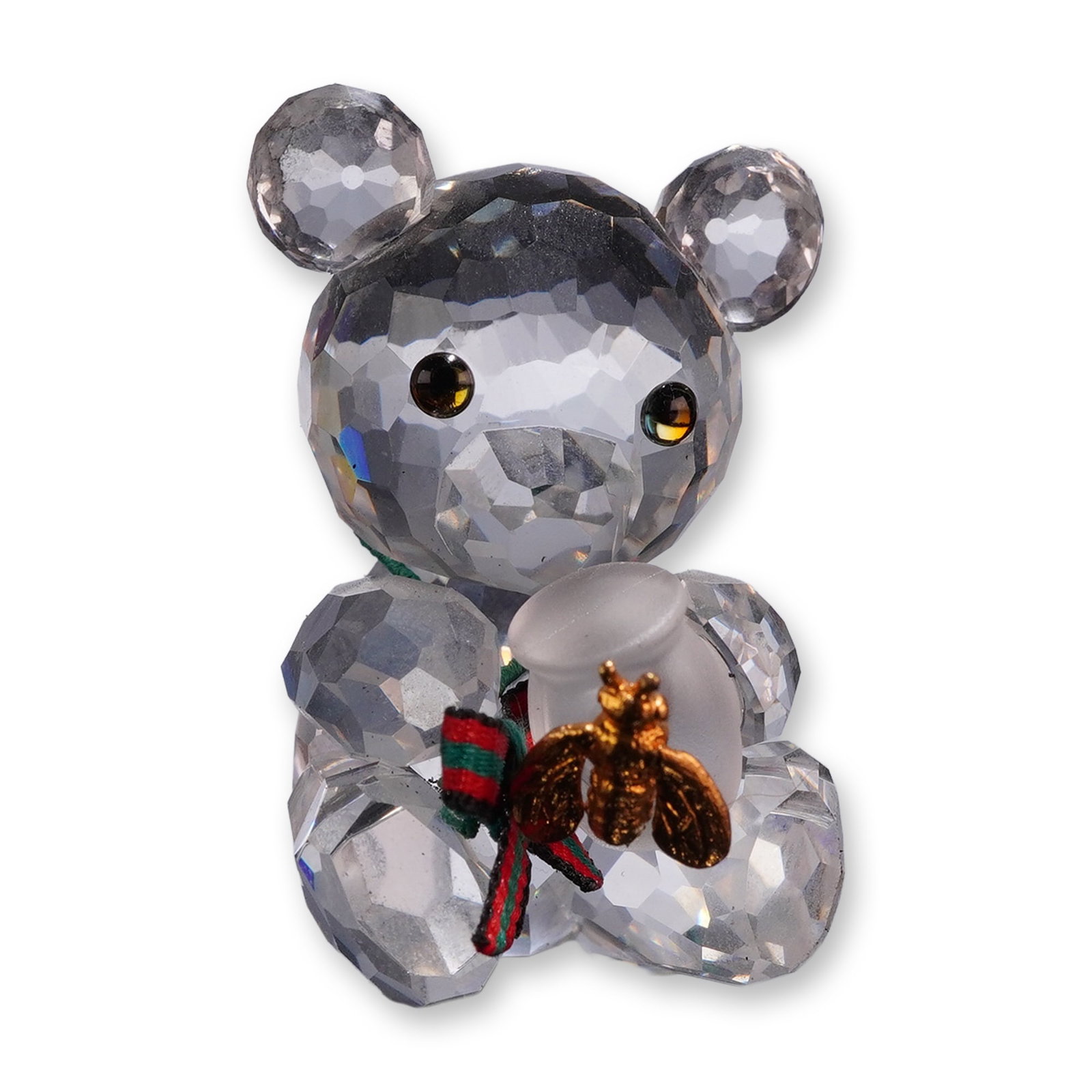 Swarovski Crystal Kris Bear Honey Pot Figurine: Swarovski Silver Crystal Kris Bear with Honey Pot figurine, model number 213068. Crafted in faceted and frosted lead crystal, depicting a seated bear holding a honey pot adorned with a gold-plated met