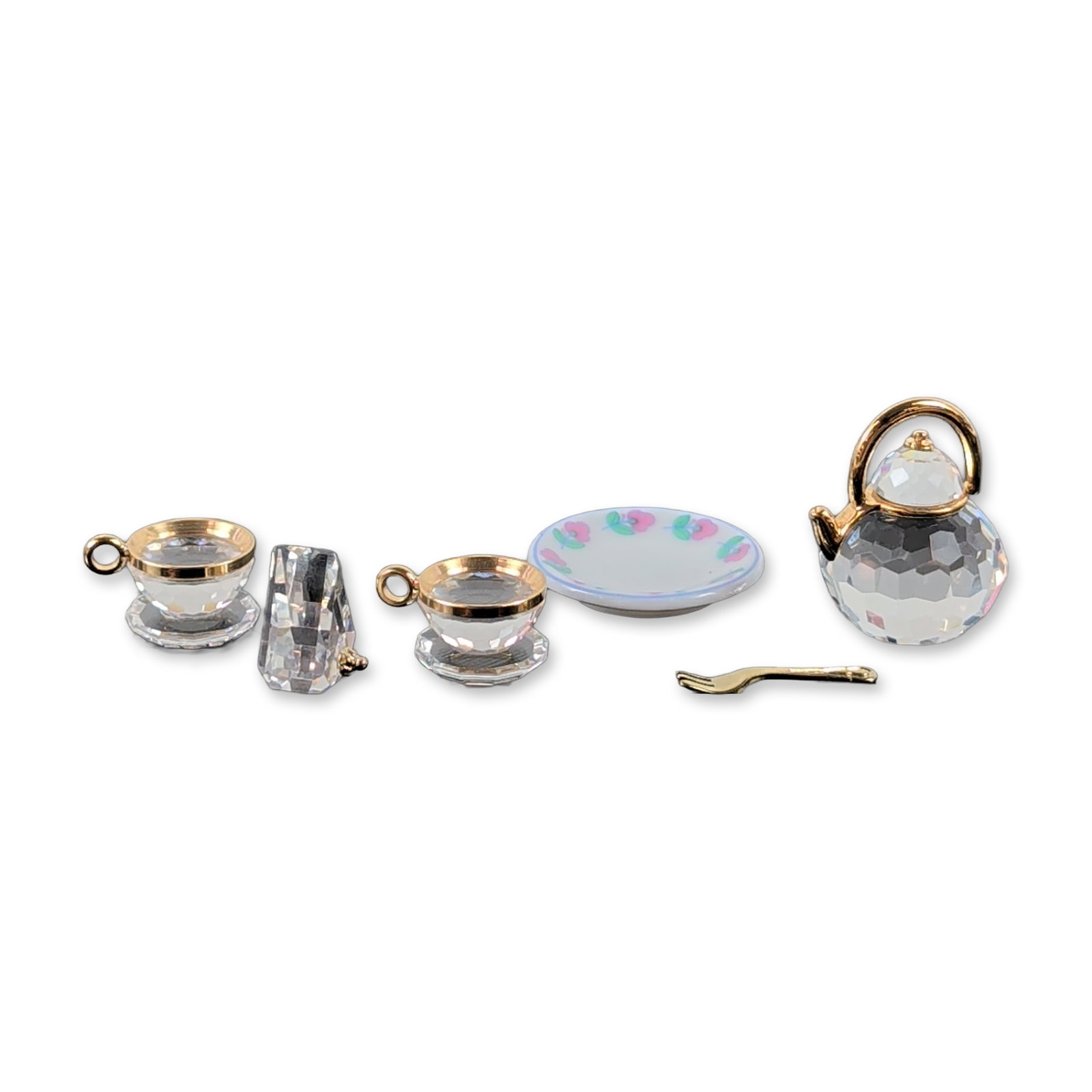 Swarovski Crystal Memories Miniature Tea Service Set: Swarovski Austrian Crystal Memories Classics miniature tea service. Set of four miniature items in faceted clear lead crystal with gold-plated metal accents and porcelain, including a teapot, two