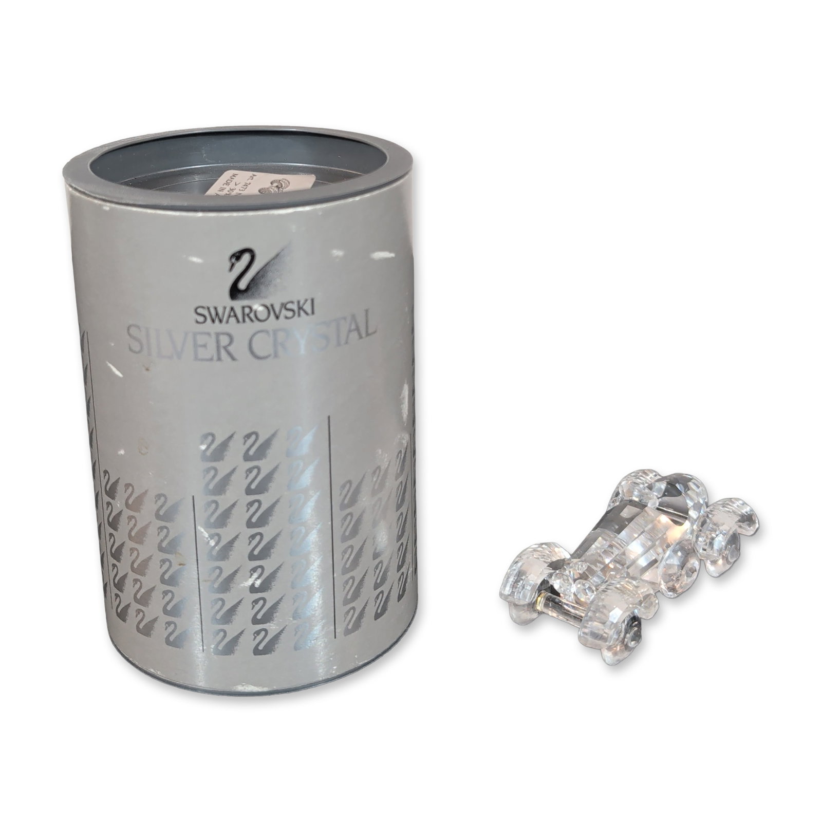 Swarovski Crystal Old Timer Vintage Car Figurine: Car figurine in faceted clear lead crystal, featuring a streamlined open-wheel body and four faceted wheels. Hand-etched signature on the bottom section. Etched swan logo on the underside. Includes or