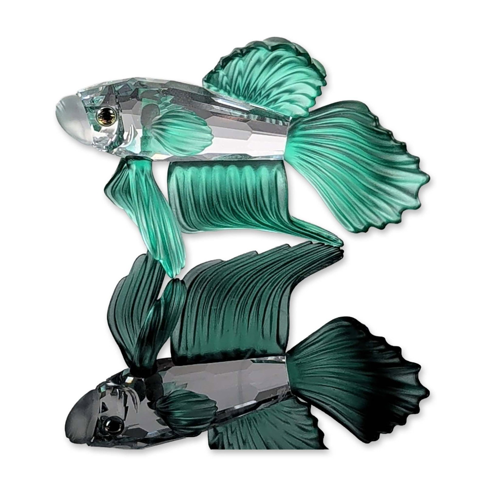 Swarovski Crystal Siamese Fighting Fish Figurine: Swarovski Siamese Fighting Fish figurine in clear and emerald green lead crystal. The piece features a clear faceted lead crystal body with textured emerald green frosted crystal fins and tail, and