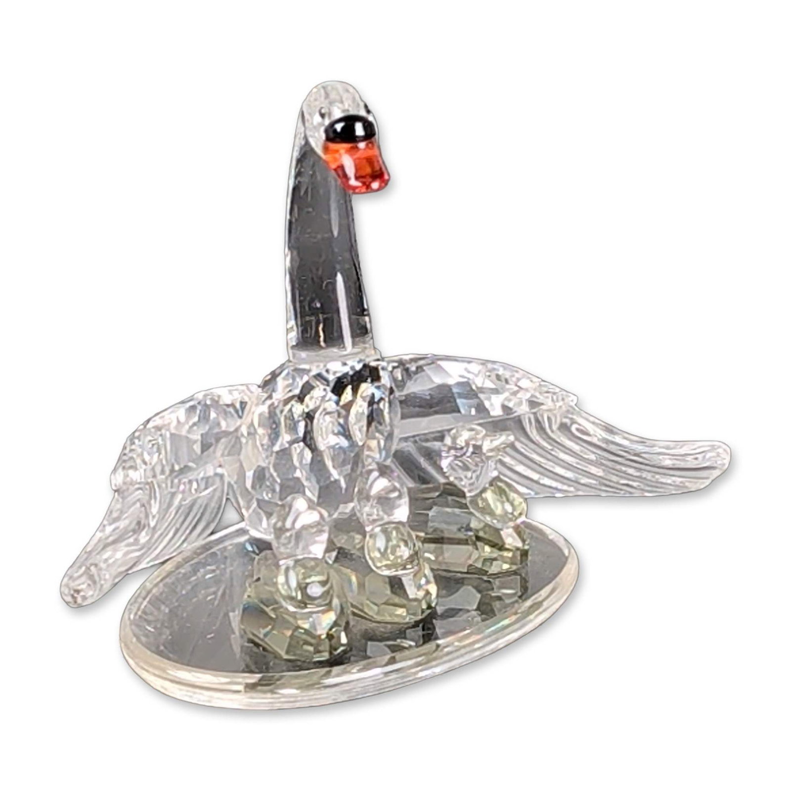 Swarovski Crystal Swan Family Figurine: Swarovski Silver Crystal Swan Family figurine from the Beauties of the Lake series. The composition features a clear faceted crystal swan and a black Jet faceted crystal swan joined at a central circu