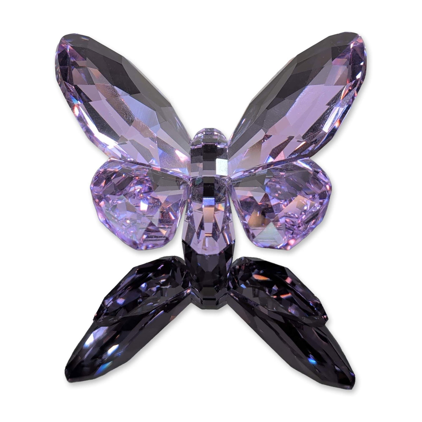 Swarovski Crystal Violet Brilliant Butterfly Figurine: Swarovski (Austrian). Butterfly figurine in violet-colored faceted lead crystal, featuring a segmented body and four wings. The piece includes an etched Swarovski swan logo and copyright symbol on a f