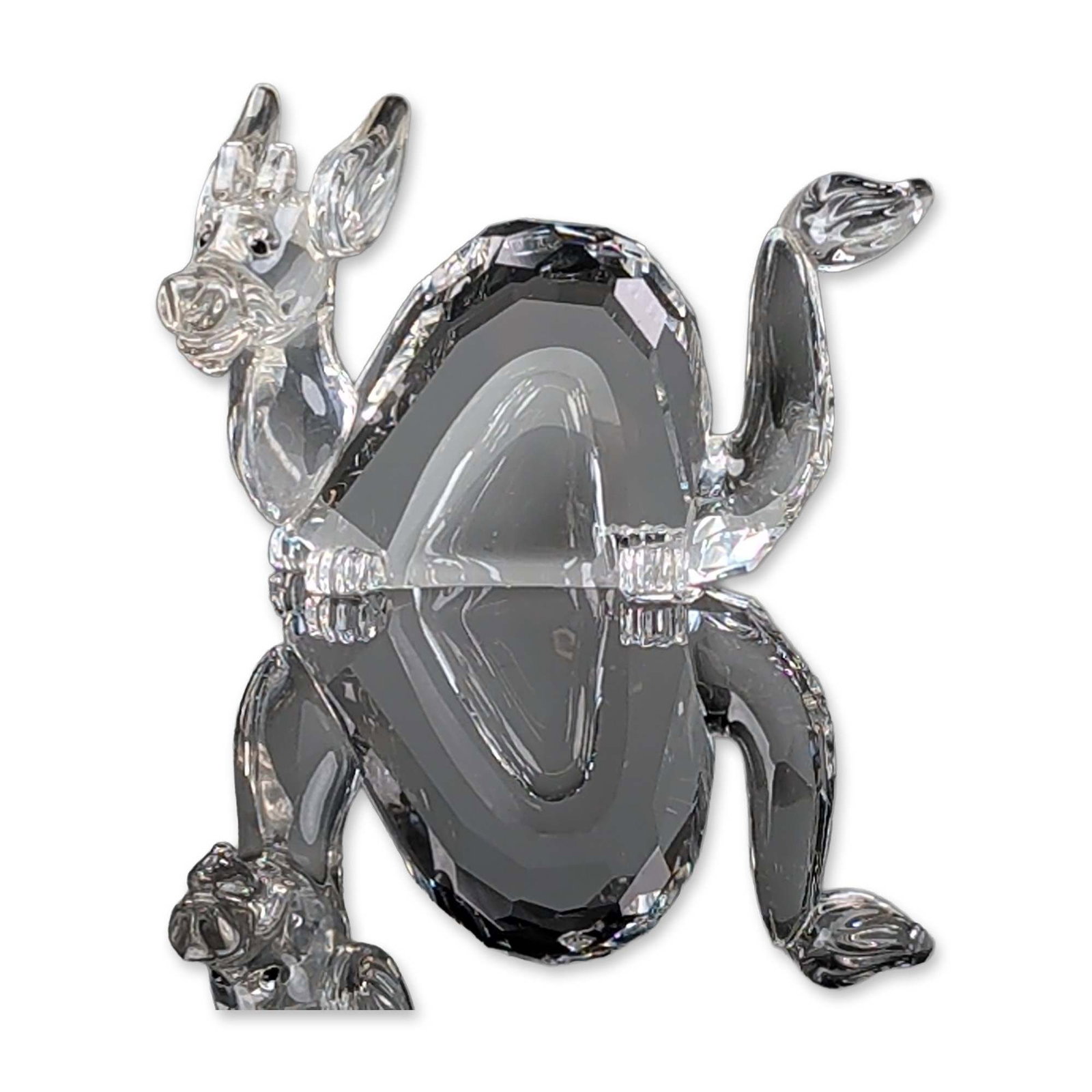 Swarovski Faceted Crystal Figurine, Zodiac Dragon: Figurine in faceted lead crystal depicting sitting dragon. The clear crystal construction features multi-faceted surfaces throughout the body and ears. The base of one paw features a laser-etched Swar