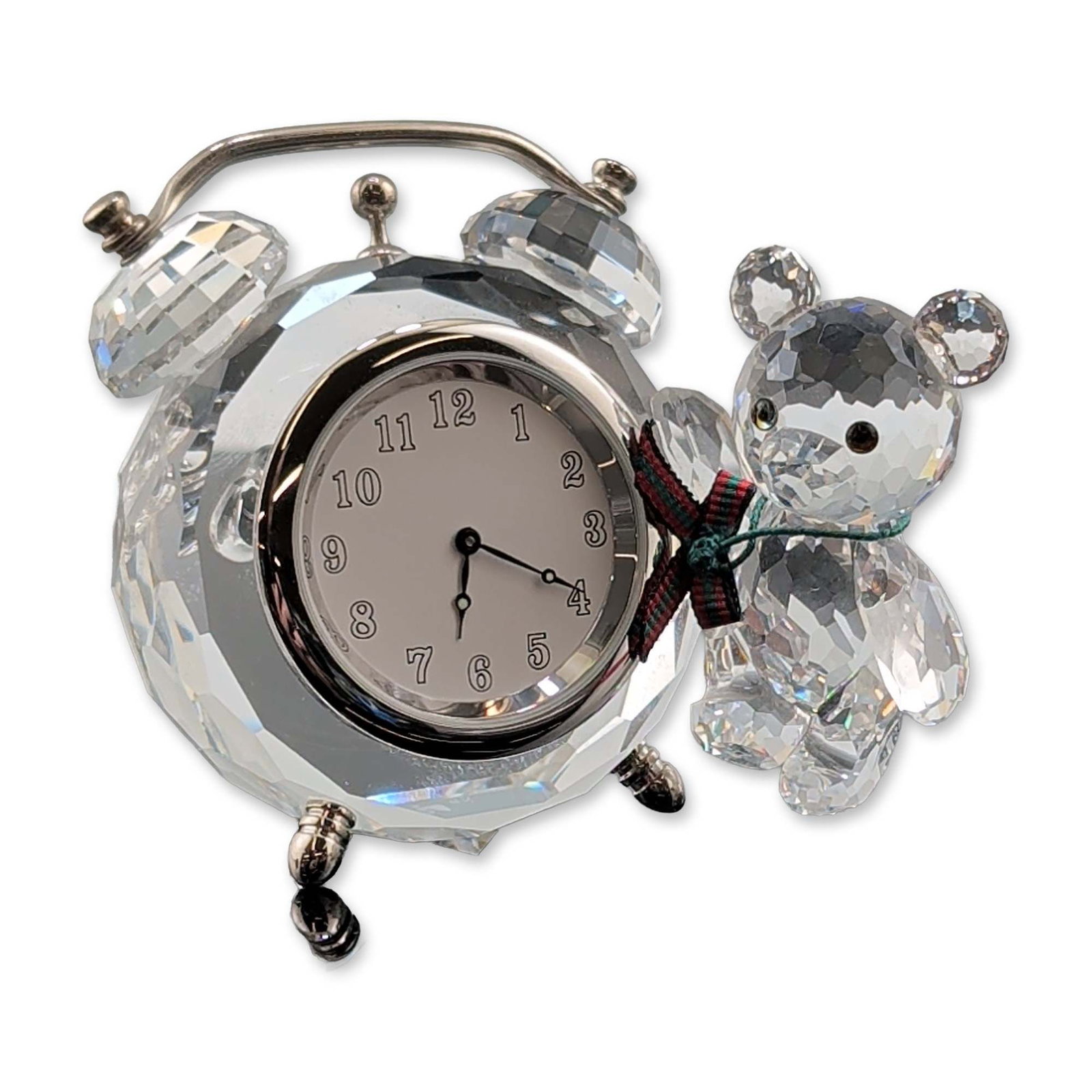 Swarovski Kris Bear Crystal Table Clock: Swarovski Austrian faceted lead crystal figurine from the Silver Crystal collection. The piece depicts a Kris Bear figure leaning on a miniature alarm clock. The bear features iridescent crystal eyes,