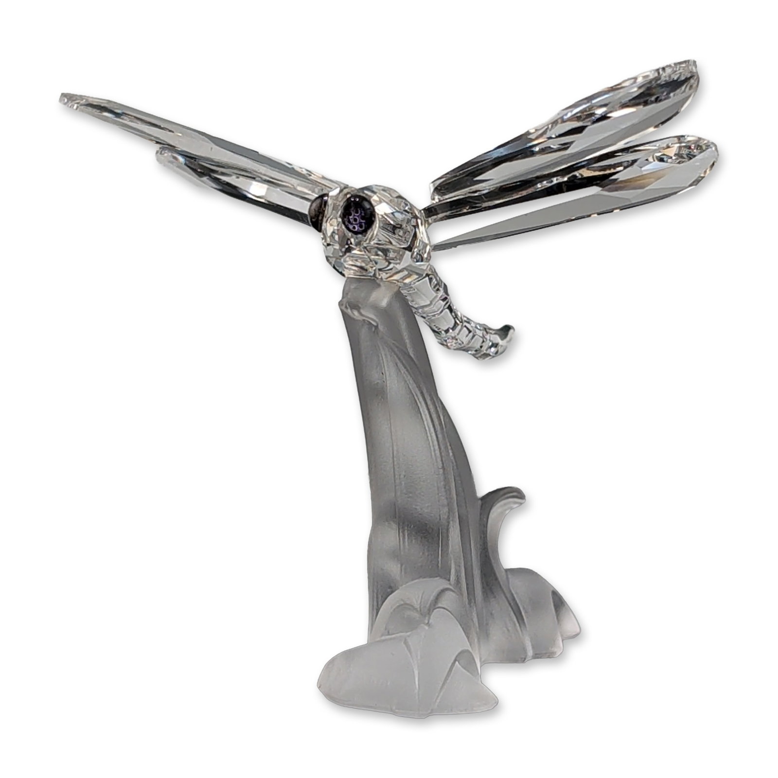 Swarovski Silver Crystal Dragonfly Figurine: Swarovski Silver Crystal Dragonfly figurine in faceted and frosted crystal, featuring a segmented clear body and four faceted wings with blue round eyes. The piece is mounted to an organic frosted cry