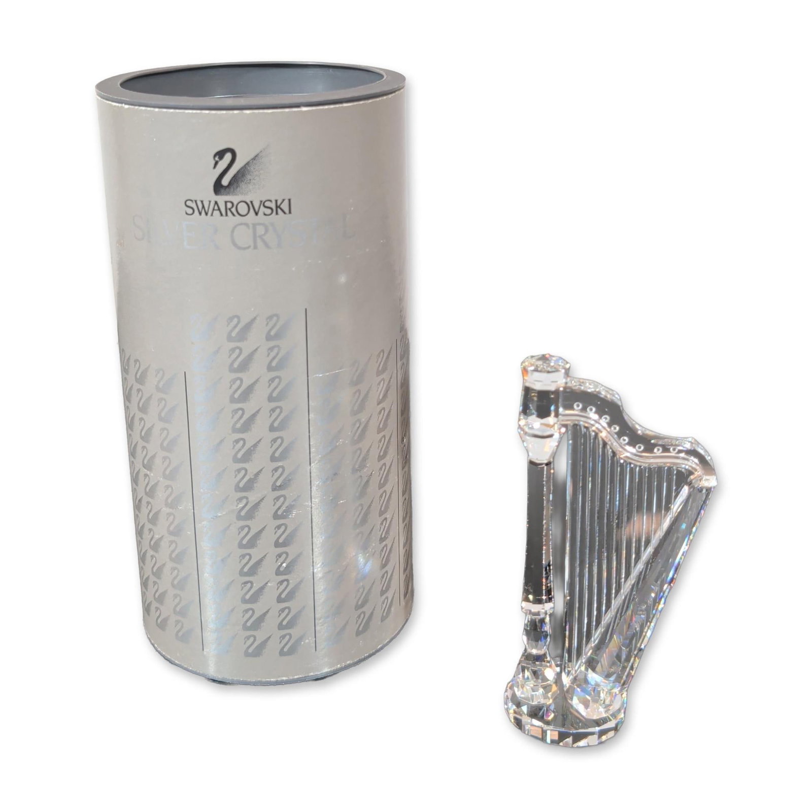 Swarovski Silver Crystal Harp Figurine: Swarovski Austrian lead crystal figurine from the Musical Instruments series, depicting a classical harp. The piece features a faceted column and soundboard with clear synthetic strings tensioned betw