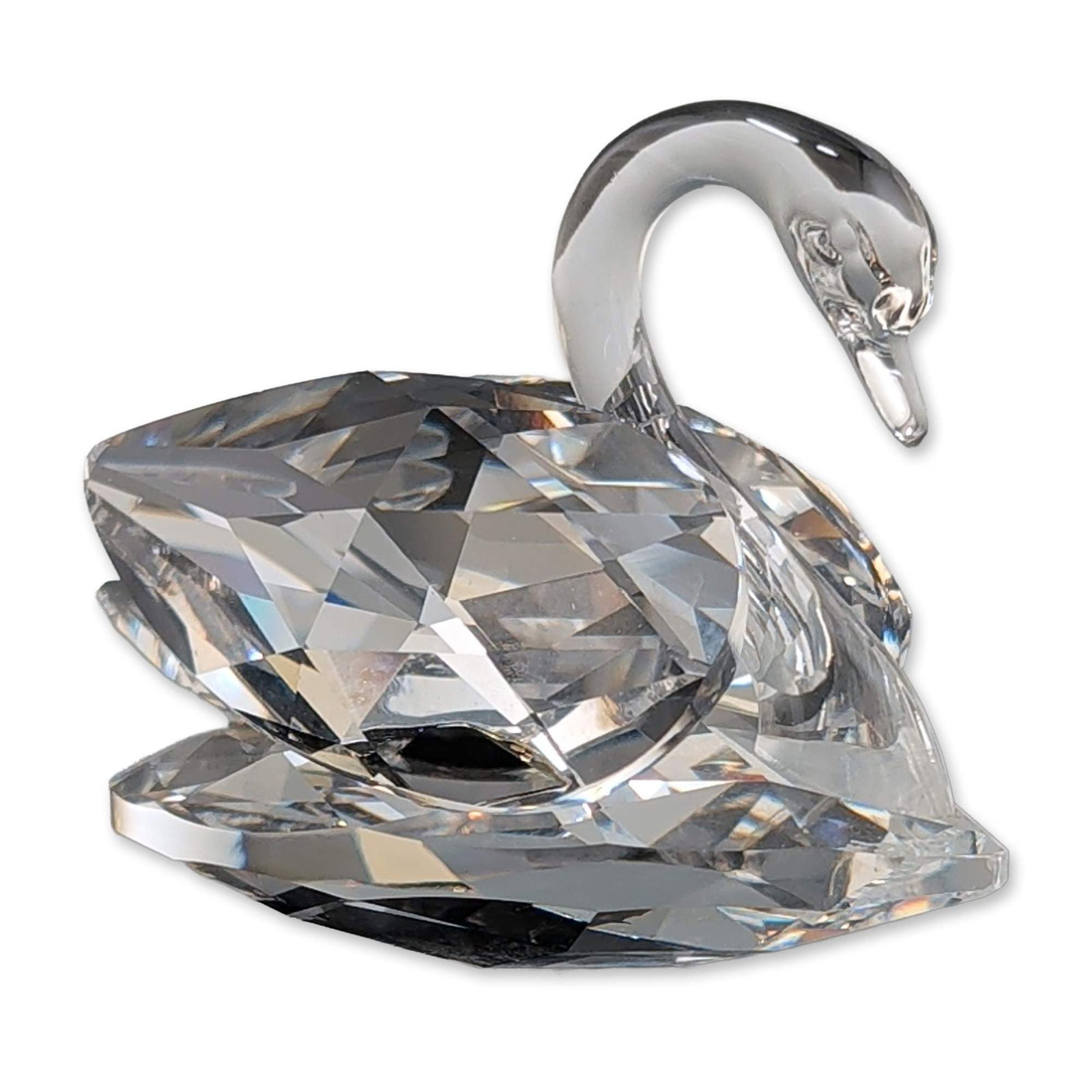 Swarovski Silver Crystal Swan Figurine: Swarovski Silver Crystal swan figurine, featuring a faceted lead crystal body and a smooth, curved neck. The underside bears an etched Block SC logo, which consists of two interlocking squares above t