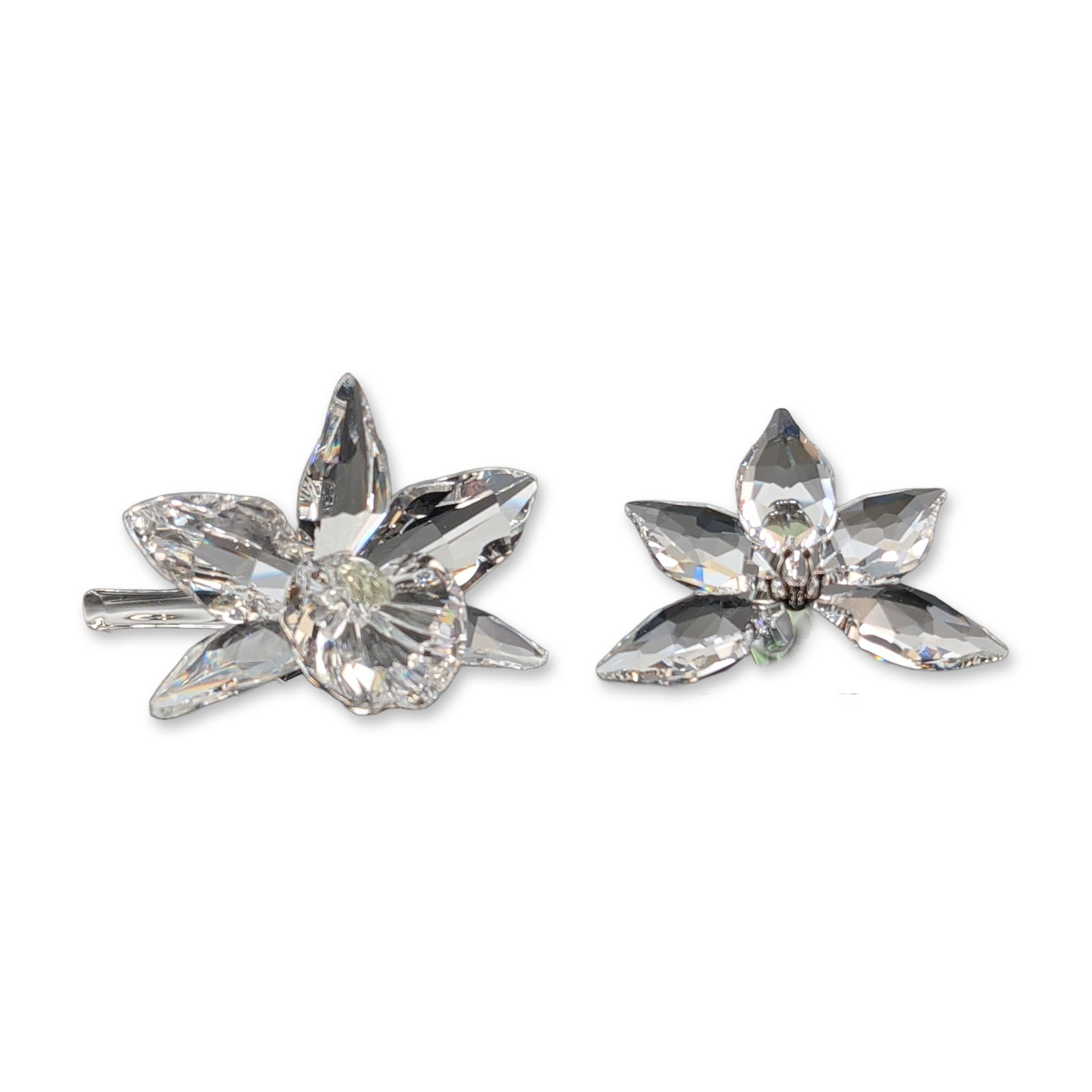 2pc Swarovski Crystal Orchid Flower Figurines: Two Swarovski botanical figurines in faceted lead crystal and colored art glass, from the Silver Crystal and Swarovski Crystal Society (SCS) collections. The group includes an orchid featuring pointed