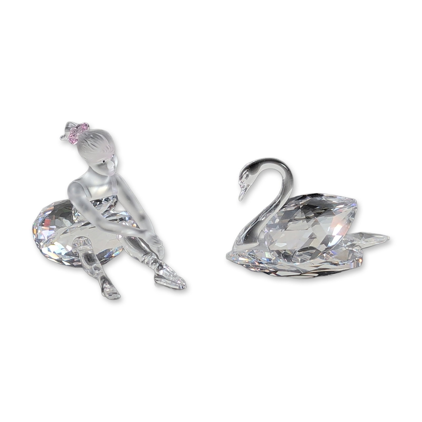 2pc Swarovski Crystal Swan and Ballerina Figurines: Swarovski lead crystal figurines, including a swan and a ballerina. The swan is constructed with a smooth surfaced neck and a multi faceted body. The ballerina features a frosted crystal head, torso, 