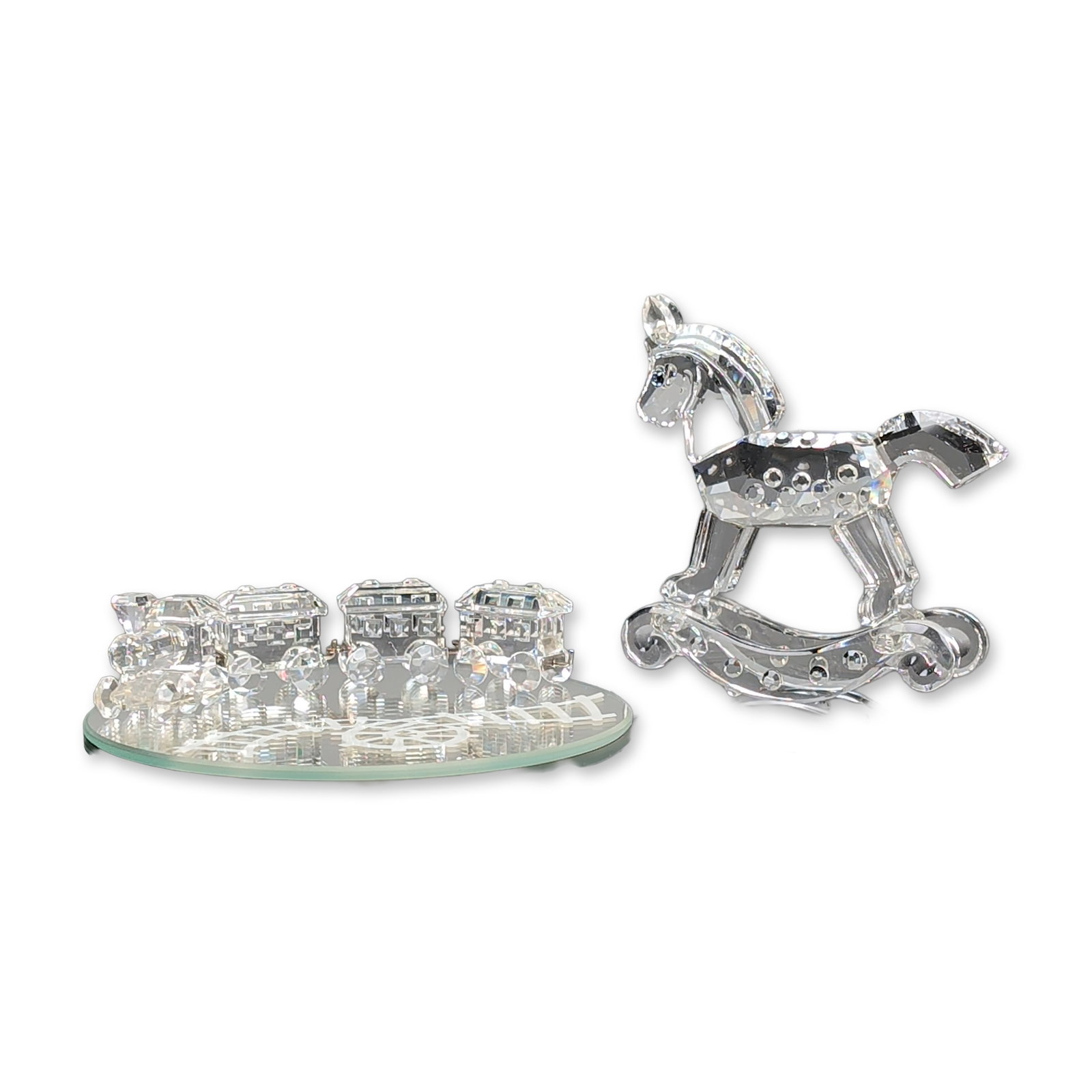 5pc Swarovski Silver Crystal Figurines and Base, Rocking Horse and Train Set: Swarovski. Group of two clear crystal figurines from the Silver Crystal line. The lot includes a multi-faceted rocking horse featuring blue crystal eyes and curved rockers with raised dot accents. The