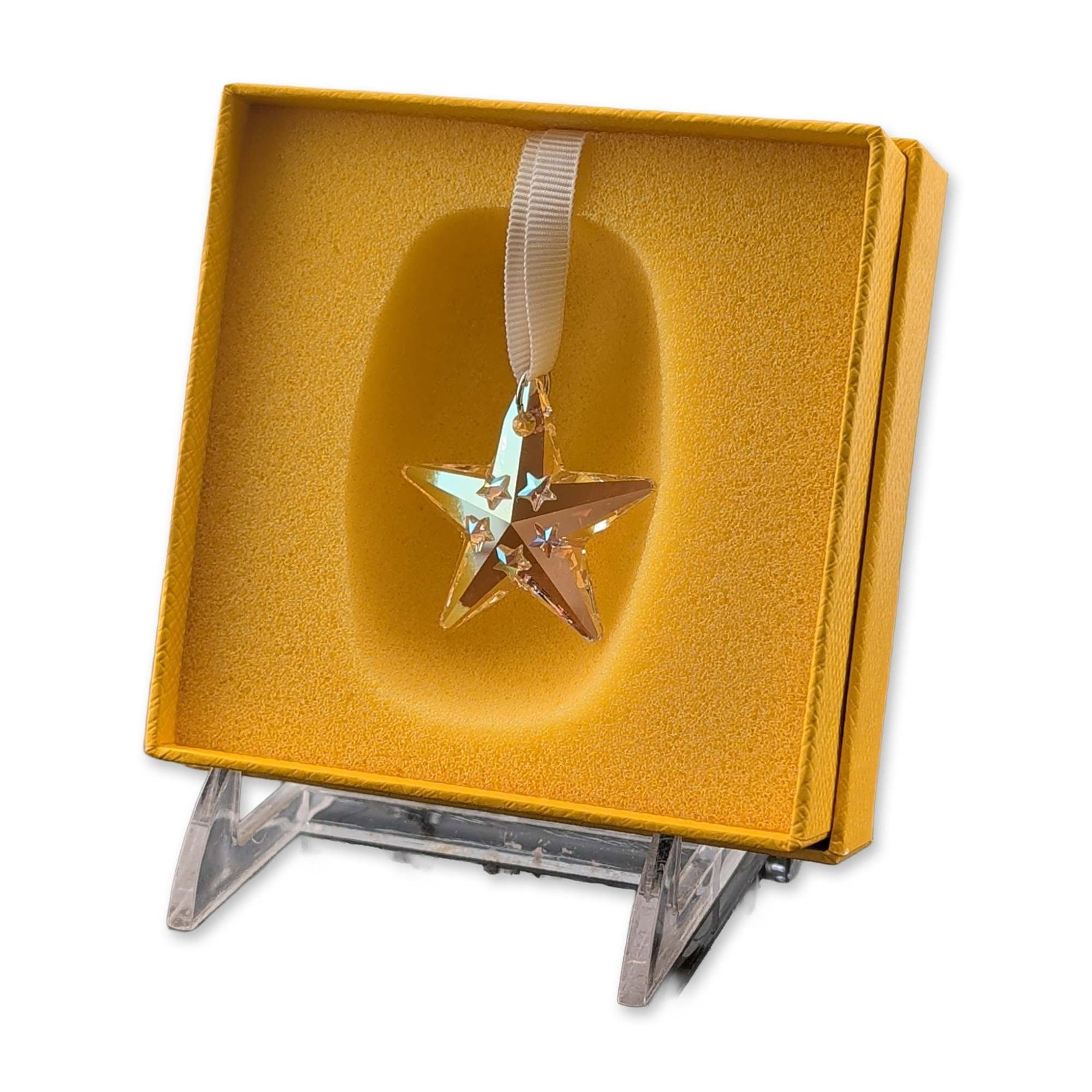 Swarovski 2024 SCS Loyalty Gift Star Ornament: Swarovski Crystal Society (SCS) 2024 Loyalty Gift star ornament crafted in faceted crystal with an Aurora Borealis iridescent coating and features five smaller star-cut crystals applied to the front s