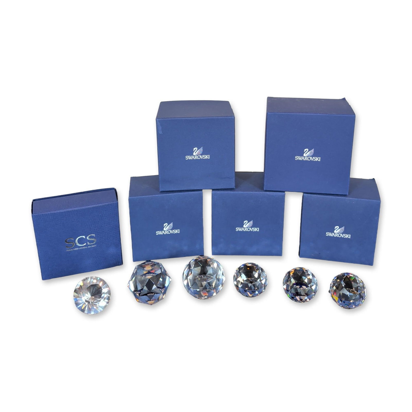 6pc Swarovski Crystal Paperweights: Collection of six faceted lead crystal paperweights featuring various internal motifs and commemorative designs. Grouping includes a 30th Anniversary Swarovski Silver Crystal commemorative piece, a Wo