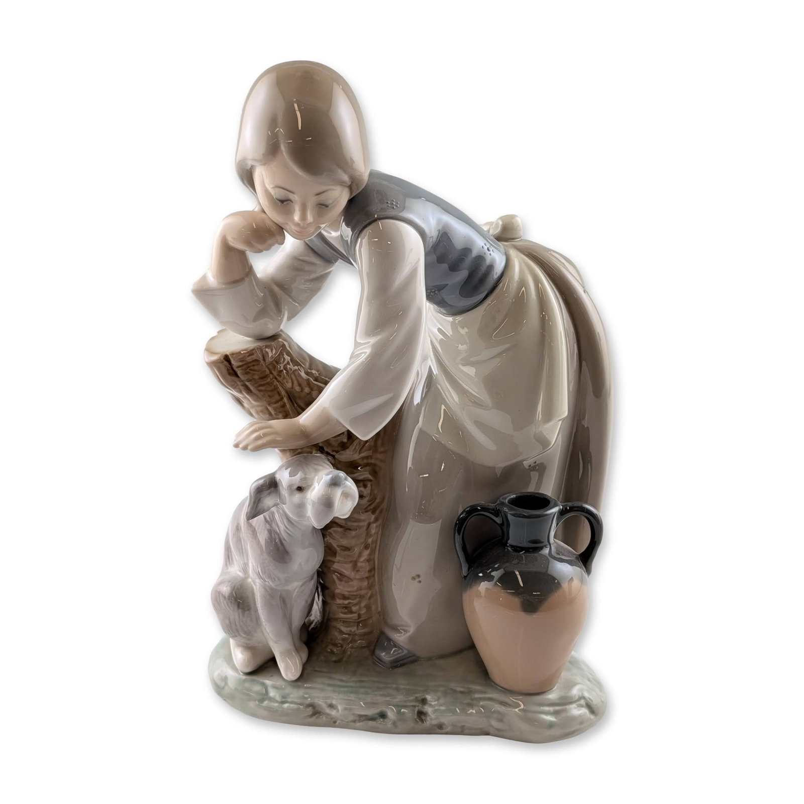 Lladro Caress and Rest Porcelain Figurine: Lladro Spanish glazed porcelain figurine titled Caress and Rest, model number 1246, designed by sculptor Juan Huerta. The piece depicts a young girl in rustic attire, including a grey bodice and tan a