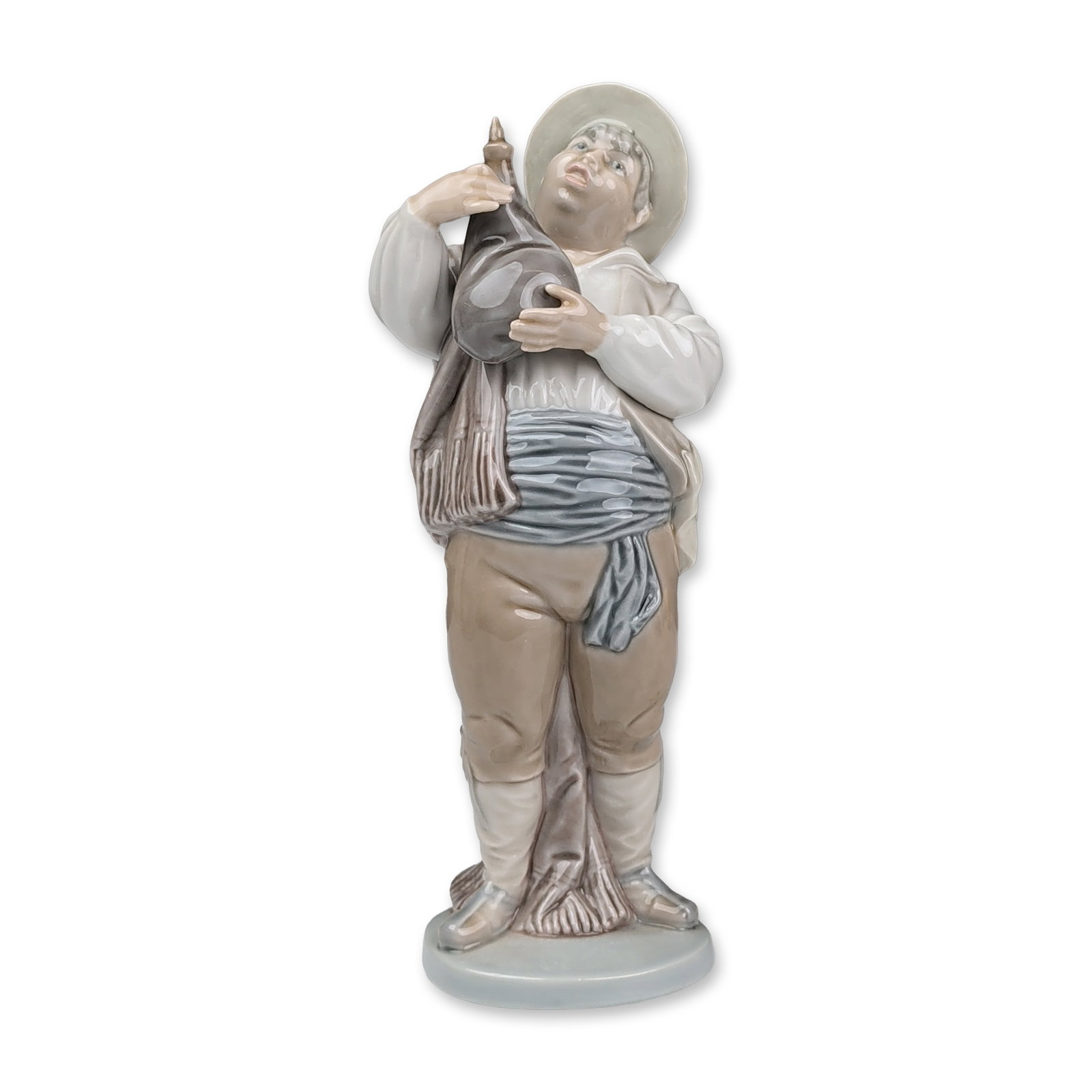Lladro Porcelain Figurine, A Toast by Sancho 01005165: Lladro glazed porcelain figurine titled A Toast by Sancho, model 5165, depicting the character Sancho Panza in traditional Spanish attire. The figure is shown wearing a broad-brimmed hat and blue wais