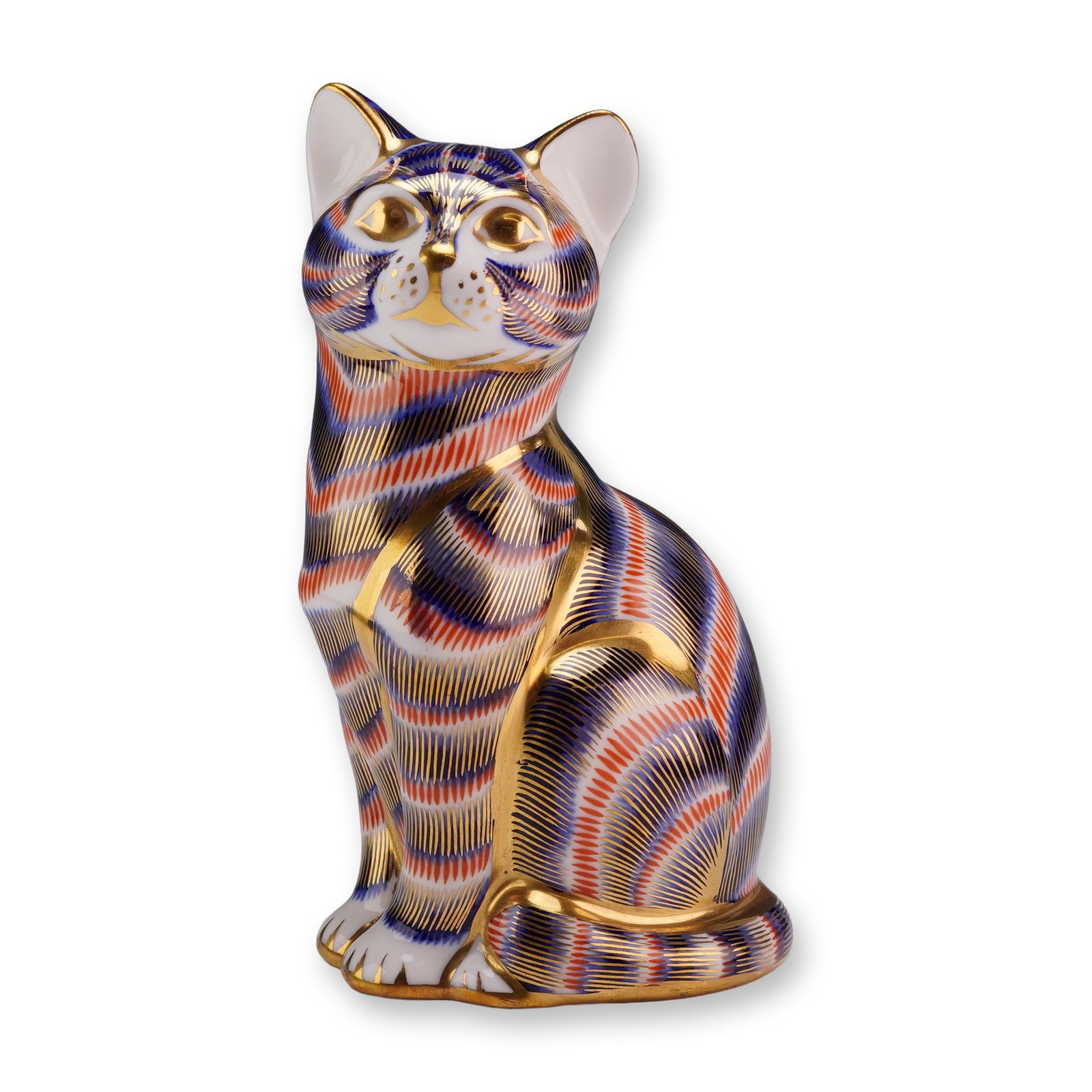 Royal Crown Derby English Bone China Paperweight, Imari Palette Seated Cat: A Royal Crown Derby fine English bone china figurine depicting a seated cat in a stylized pose with its head tilted slightly upward. The piece is decorated in the traditional Imari palette, featuring 