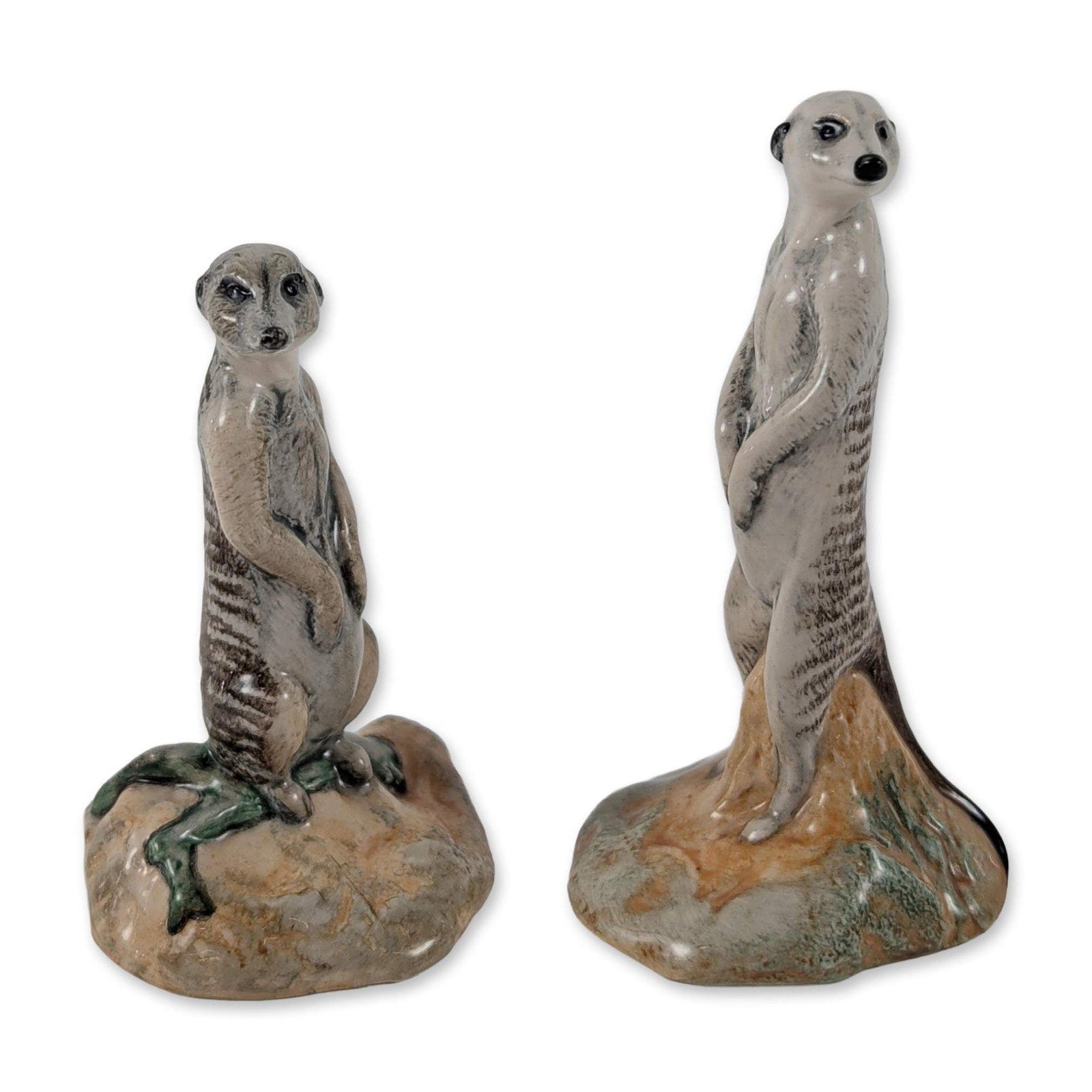 2pc John Beswick Ceramic Meerkat Figurines: John Beswick (UK Doulton) glazed ceramic meerkat figurines. Each figure is naturalistically modeled, with one in an upright sentinel pose and the other in a upright but seated position, both set on ro