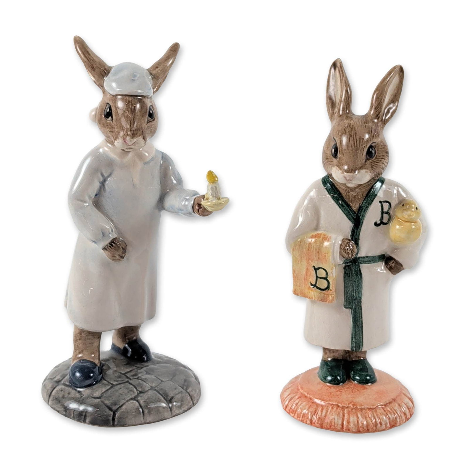 Pair of Royal Doulton Bunnykins Porcelain Figurines: Royal Doulton. Pair of glazed porcelain figurines from the Bunnykins series, including Bathtime Bunnykins (DB 148) and Wee Willie Winkie Bunnykins (DB 270). The Bathtime figure depicts a rabbit in a w