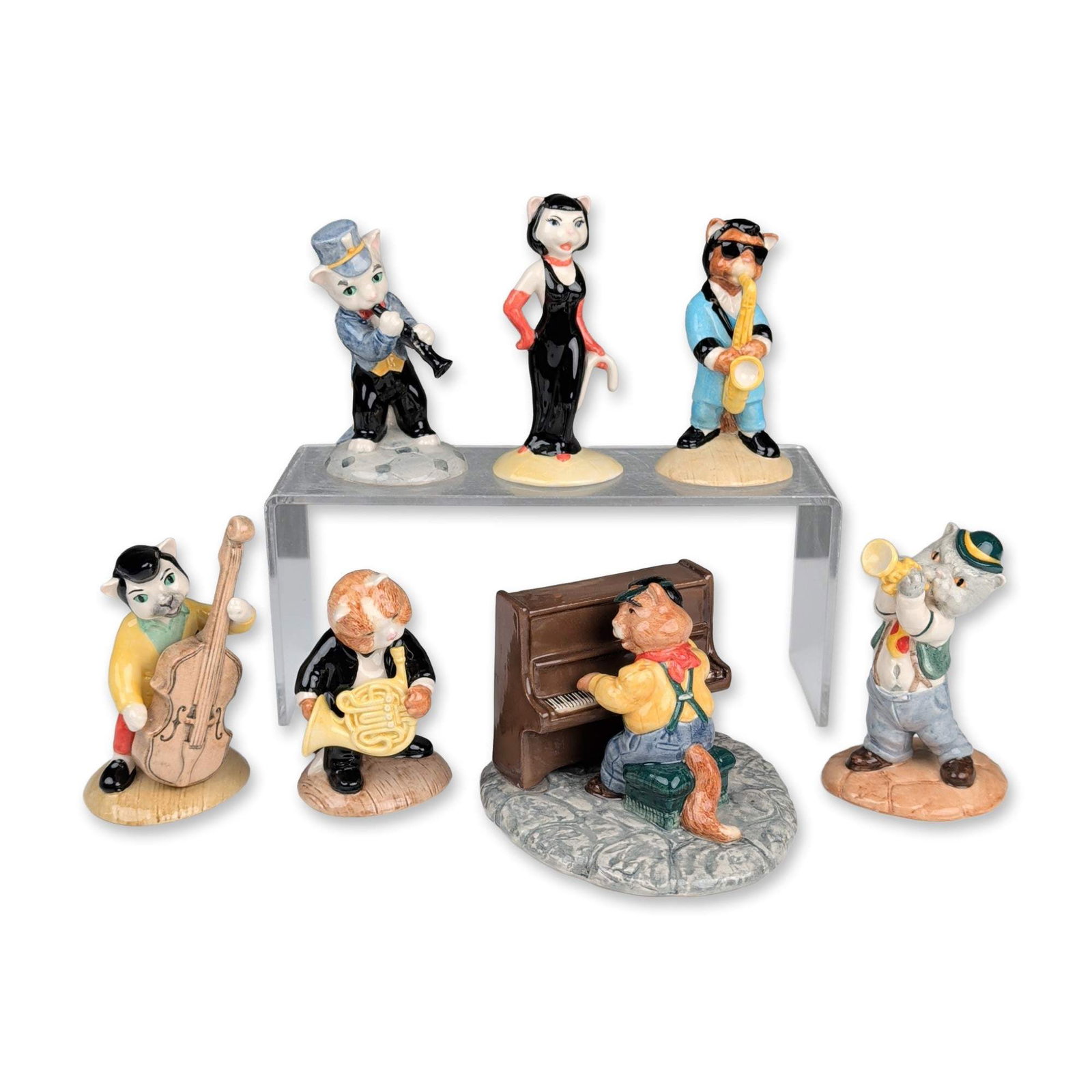 7pc Beswick Cats Chorus Figurines: Beswick, England. Set of seven ceramic figurines from the Cats Chorus series, depicting anthropomorphic feline jazz musicians. The collection includes characters playing various instruments: a vocalis