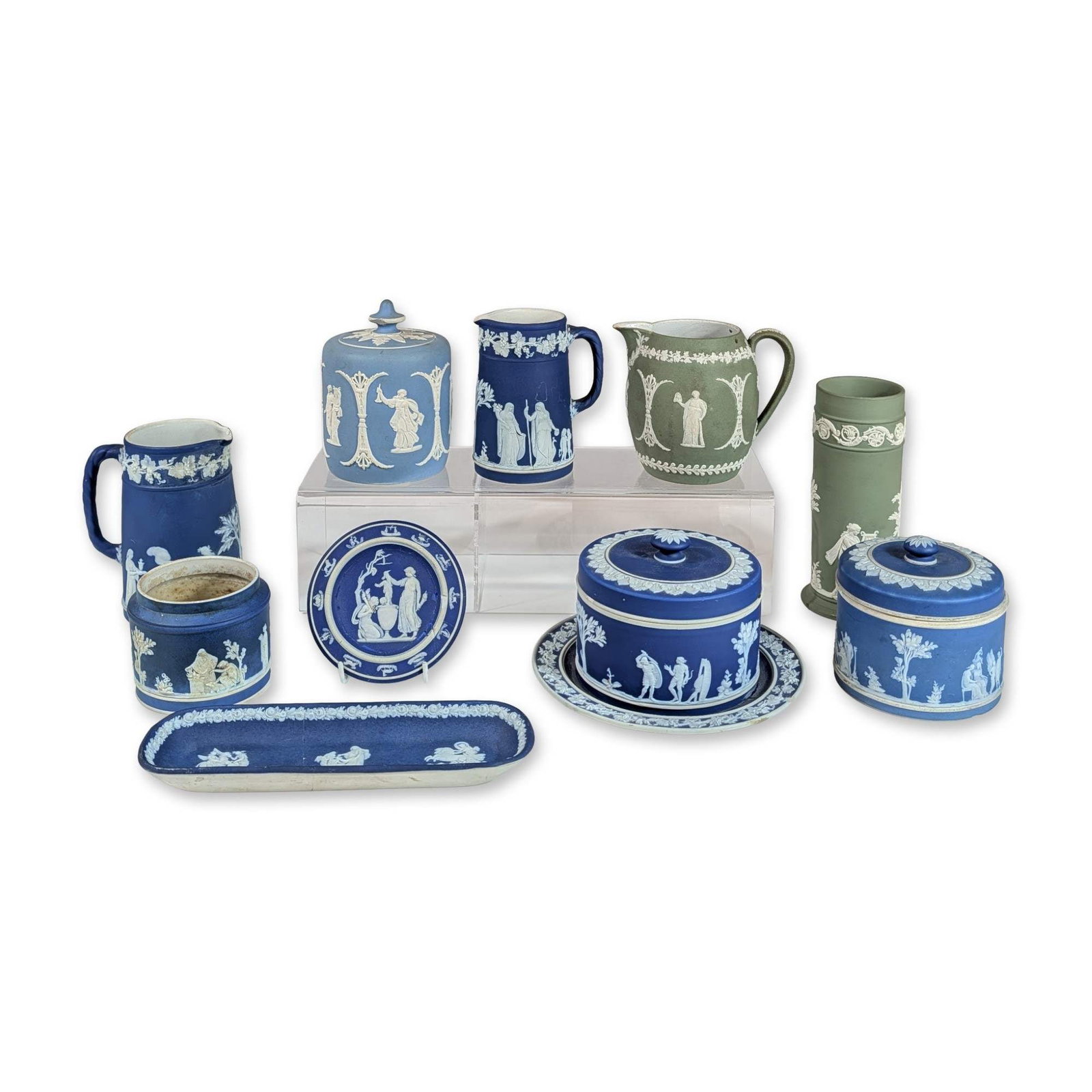 10pc Collection of Wedgwood Jasperware: Collection of ten pieces of Wedgwood Jasperware ceramics in cobalt blue, light blue, and sage green. The group features matte-finished stoneware bodies with applied white sprigged bas-relief decoratio
