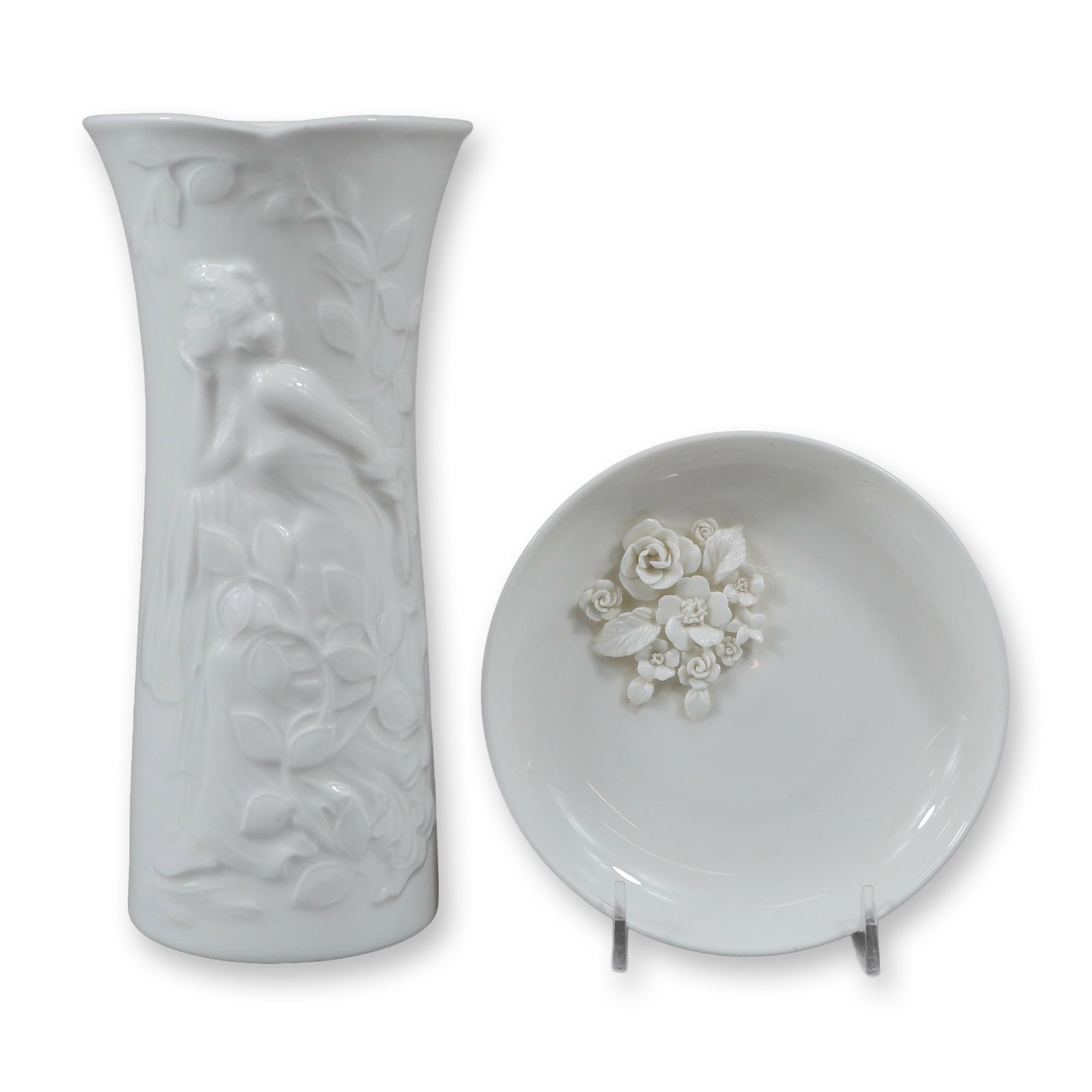 2pc Wedgwood White Glazed Porcelain John Bromley Vase and Petal Tray: A two-piece lot of white glazed porcelain manufactured by Wedgwood. The collection includes a tall, slender vase and a shallow circular tray. The vase is titled The John Bromley Vase and was produced 