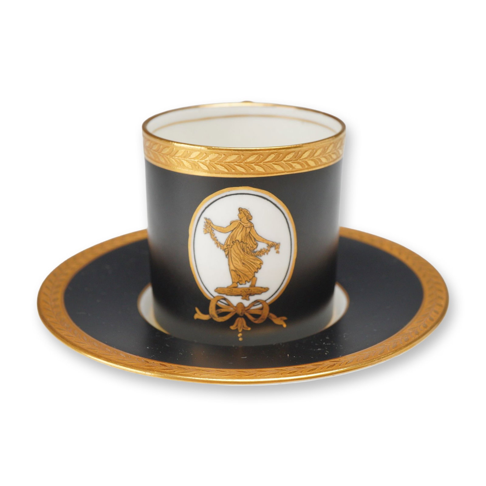 2pc Wedgwood Bone China Demitasse Cup and Saucer, circa 1915: A two-piece Wedgwood bone china demitasse cup and saucer set, identified as part of the Bicentenary Celebration and featuring the Etruscan Dance pattern. The set is decorated with a matte black ground