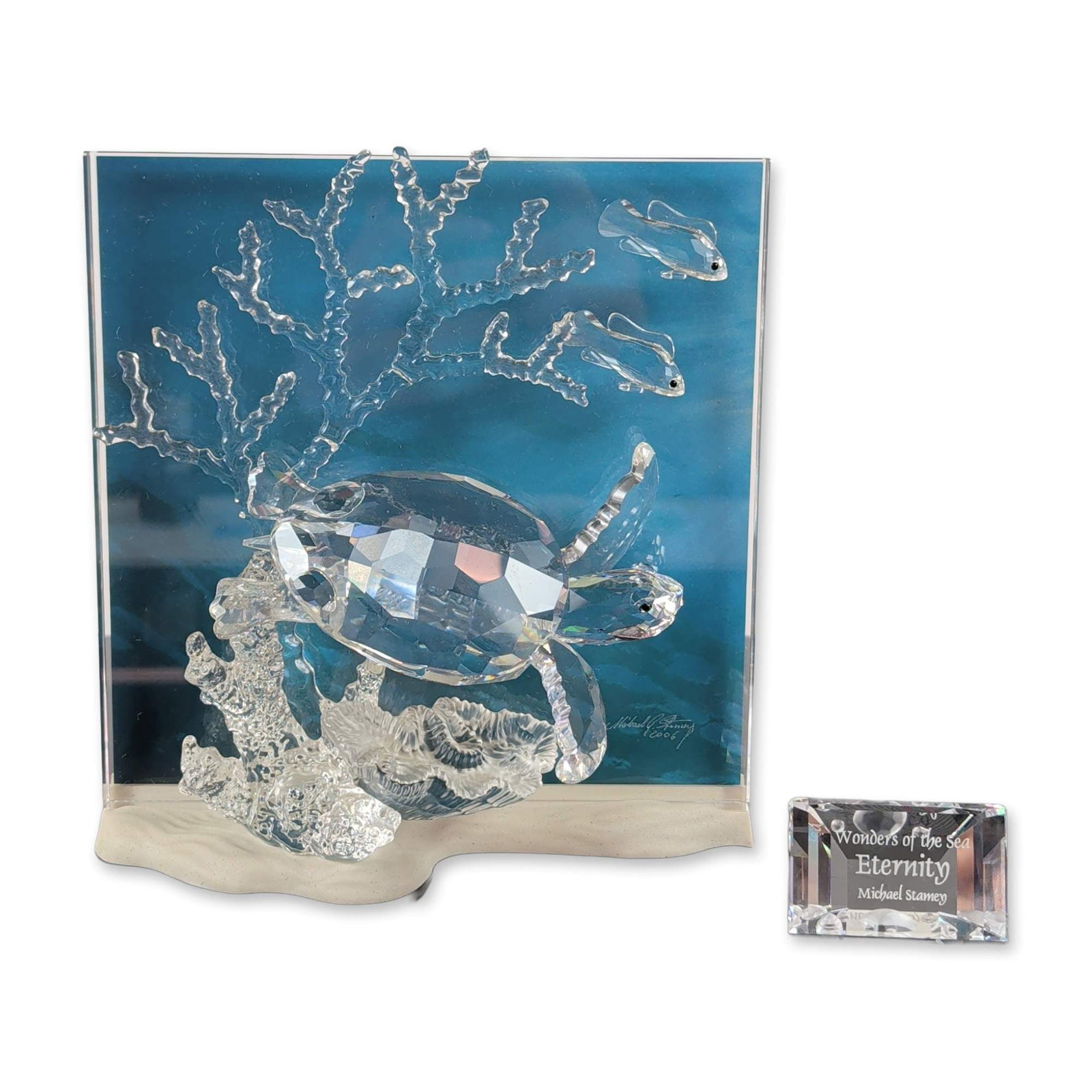 Swarovski Wonders of the Sea Eternity Crystal Sculpture: Swarovski crystal sculpture titled Eternity, designed by Michael Stamey for the Wonders of the Sea series, 2006. The work features a faceted clear crystal sea turtle and two small fish positioned over