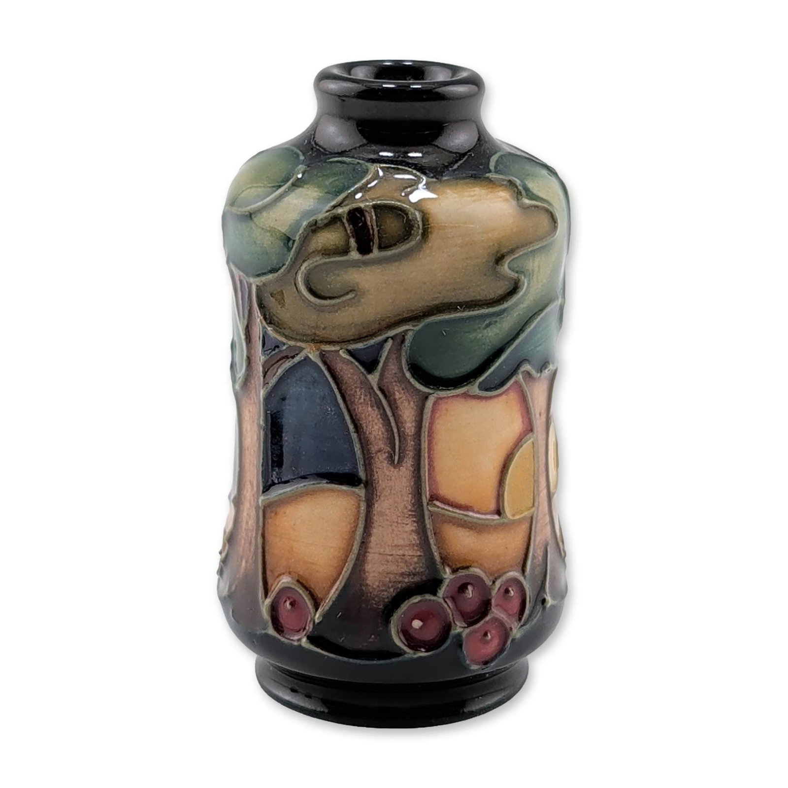 Moorcroft Pottery Miniature Vase, Trees at Sunset: Modern Moorcroft miniature pottery vase in the Tribute to Trees pattern, featuring a tubelined stylized landscape with intertwining trees and clusters of red berries against an ochre and deep blue gro