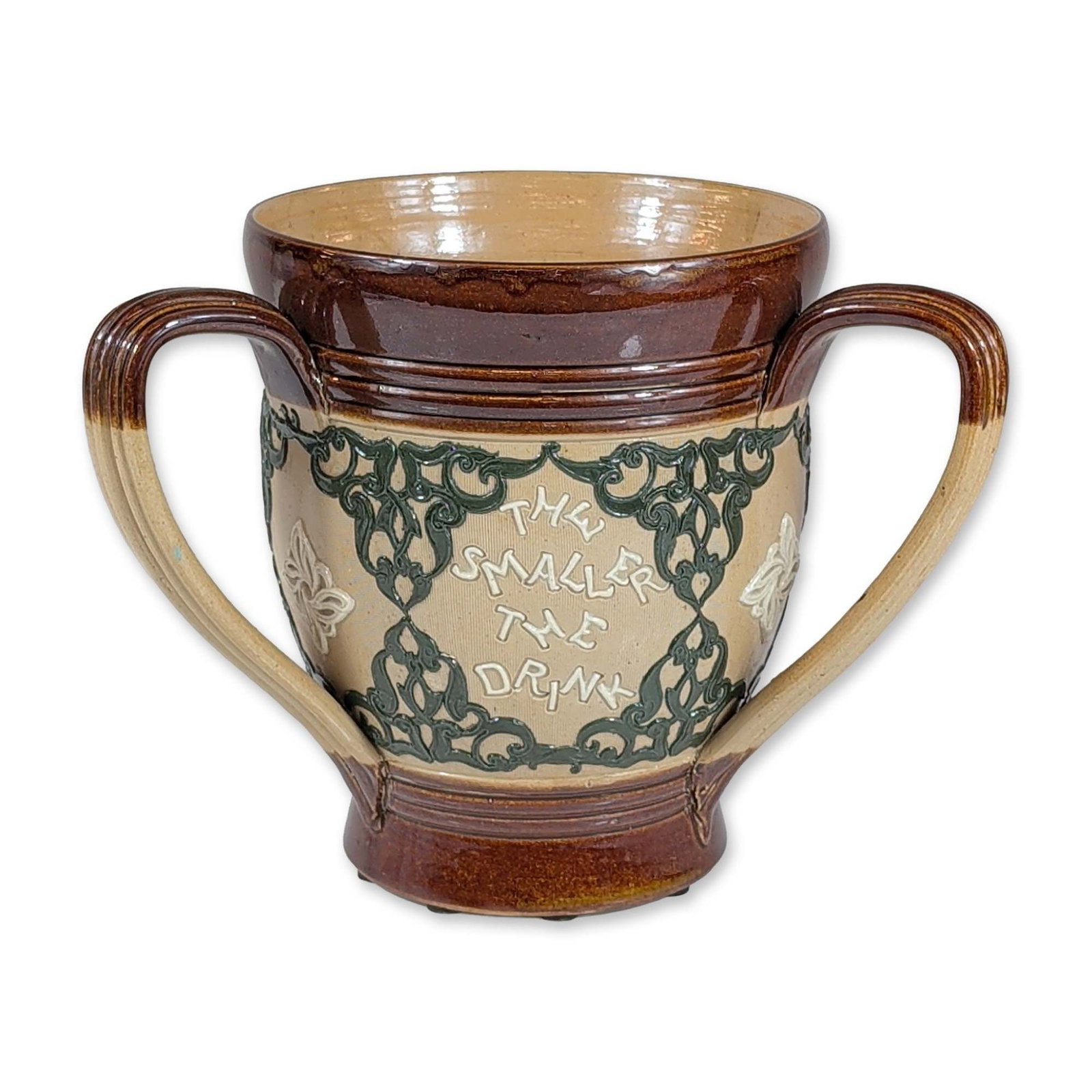 Royal Doulton Earthenware Three-Handled Proverb Tyg: English glazed earthenware three-handled tyg featuring a central buff-colored band decorated with sgraffito incised text and green foliate scrollwork. The upper rim, base, and three handles are finish