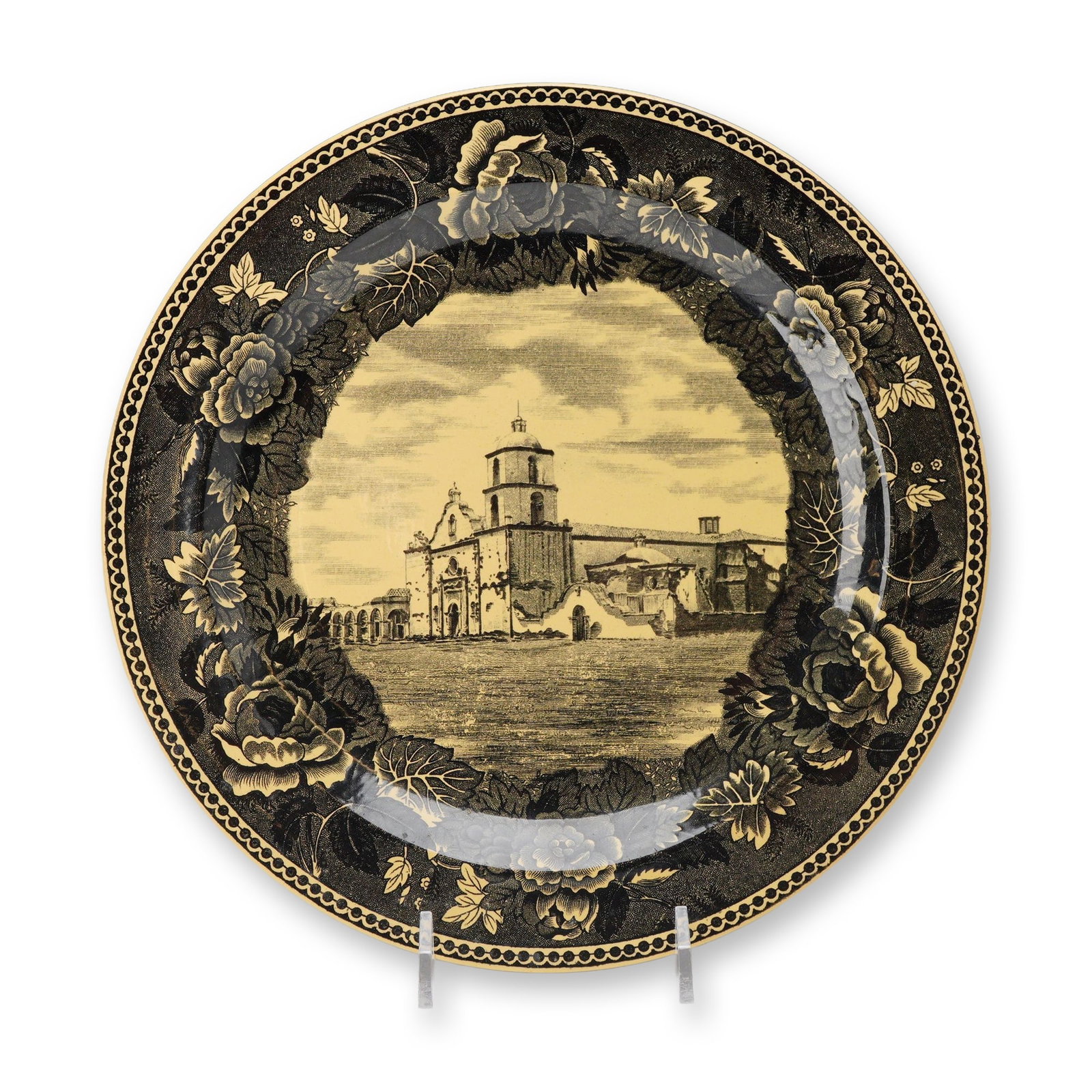 Wedgwood Creamware San Luis Rey de Francia Mission Plate: This Wedgwood earthenware plate features a yellow glaze with black transfer-printed decoration. The center displays a view of the San Luis Rey de Francia Mission, while the rim is decorated with a bor