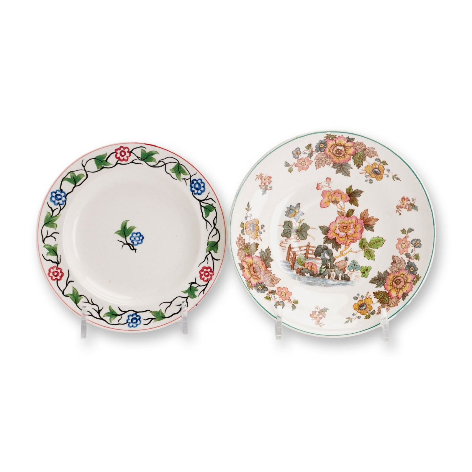 2pc Wedgwood Ceramic Small Plates: Wedgwood, England. Pair of small ceramic plates in earthenware and ironstone. One plate features a hand-painted floral border of black scrolling vines, green leaves, and alternating red and blue flowe