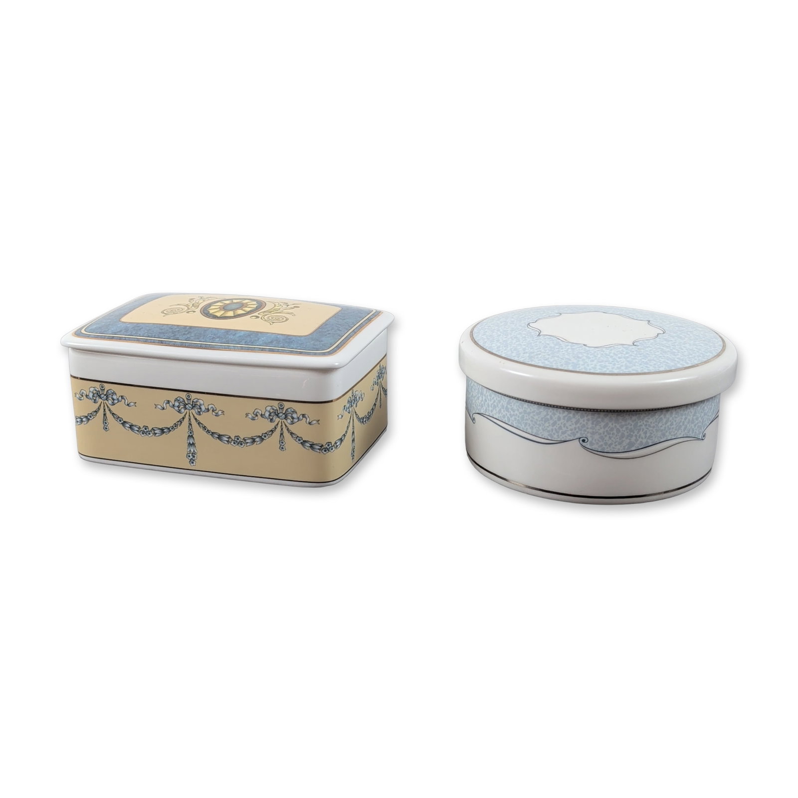 Two Wedgwood Bone China Lidded Jewelry Boxes: Two Wedgwood fine bone china lidded trinket boxes in the Venice and Madeleine patterns. The circular Venice box is decorated with a light blue and white scrollwork and foliate border on a white ground
