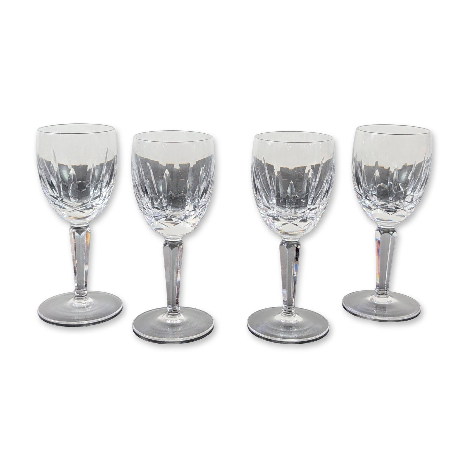 4pc Waterford Kildare Crystal Goblets: Waterford Crystal. Set of four wine or water goblets in lead crystal, featuring the Kildare pattern with a band of diamond-cut cross-hatching surmounted by vertical wedge-cut flutes. Each piece is des