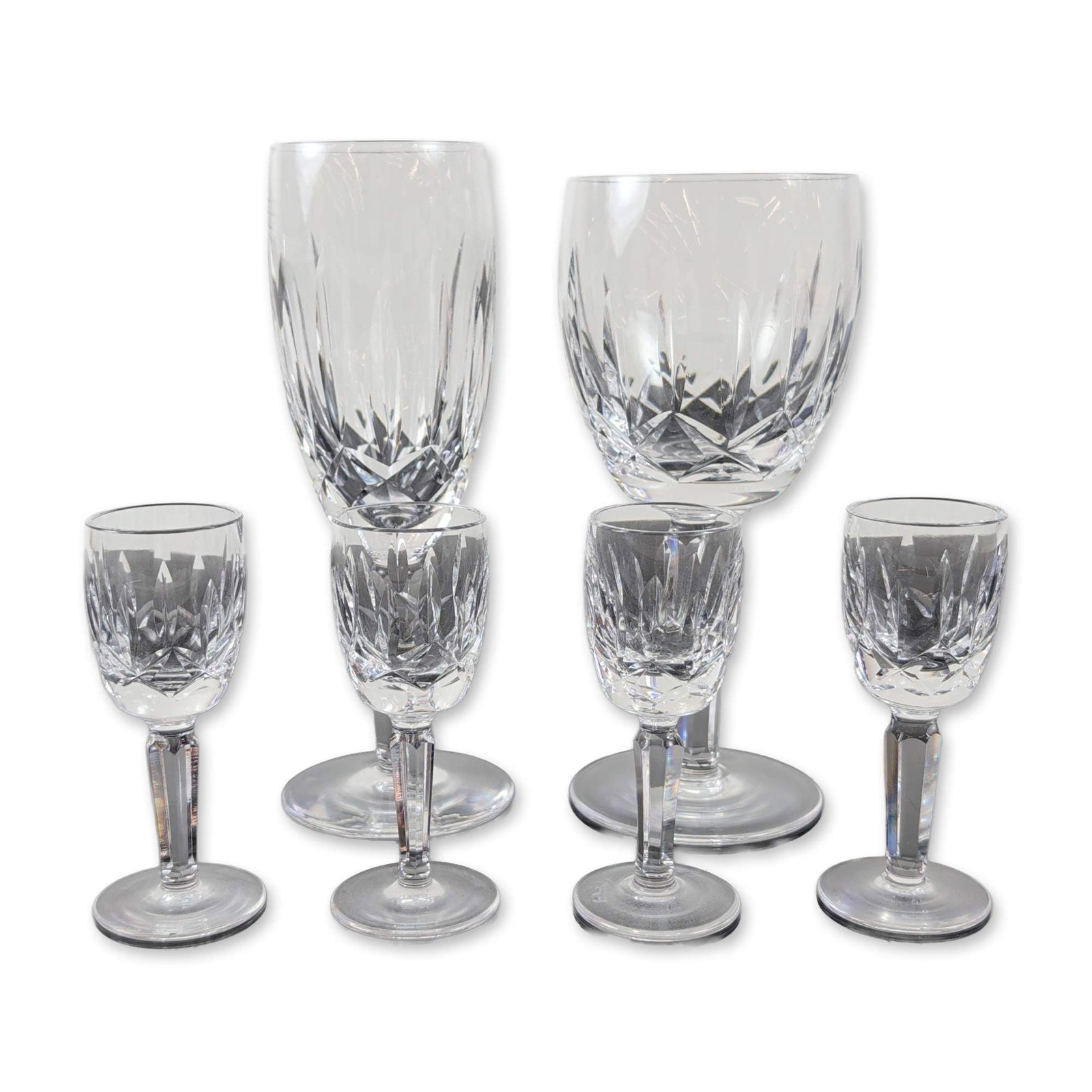 6pc Waterford Kildare Crystal Stemware Group: From Waterford, Ireland, this set of lead crystal stemware in the Kildare pattern includes a water goblet, a champagne flute, and four cordial glasses. The design showcases deep hand-cut vertical mitr