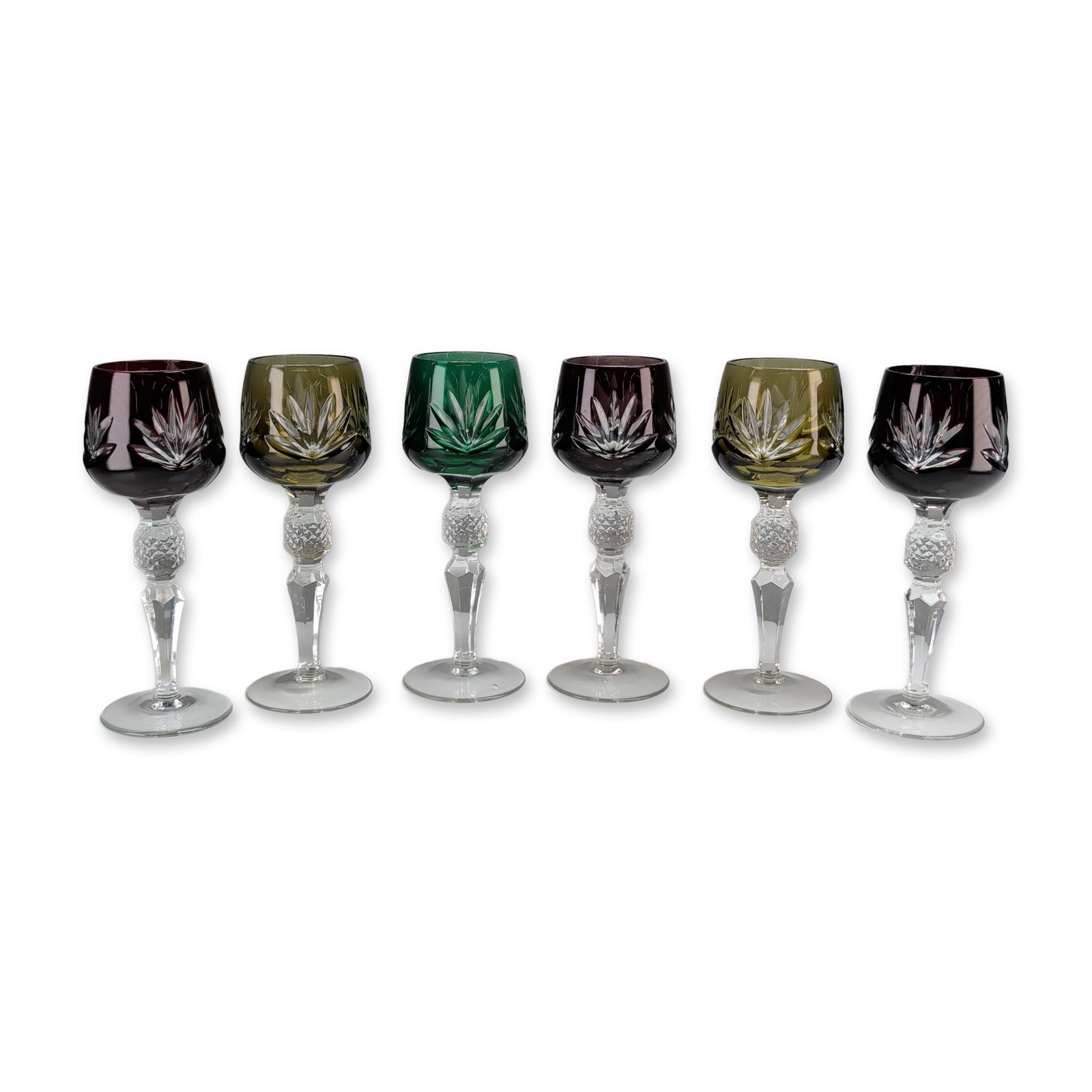 6pc Bohemian Cut to Clear Crystal Cordial Glasses: Nachtmann (German). Set of six wine or hock glasses in the Traube pattern, executed in cut-to-clear crystal. The grouping comprises three ruby-red, two amber, and one emerald-green example. Each bowl 